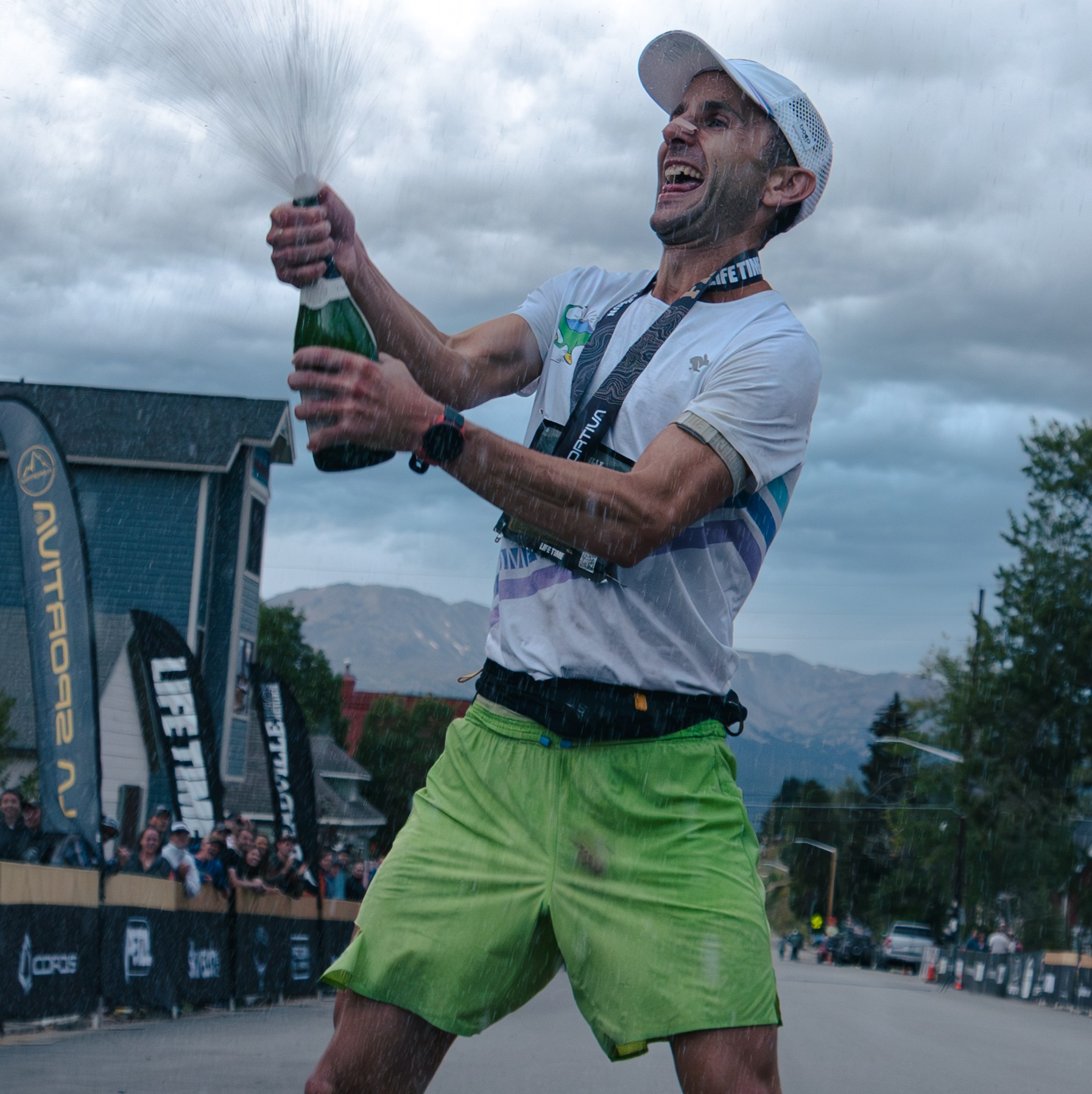David Roche sprays a bottle of champagne after winning the Leadville 100
