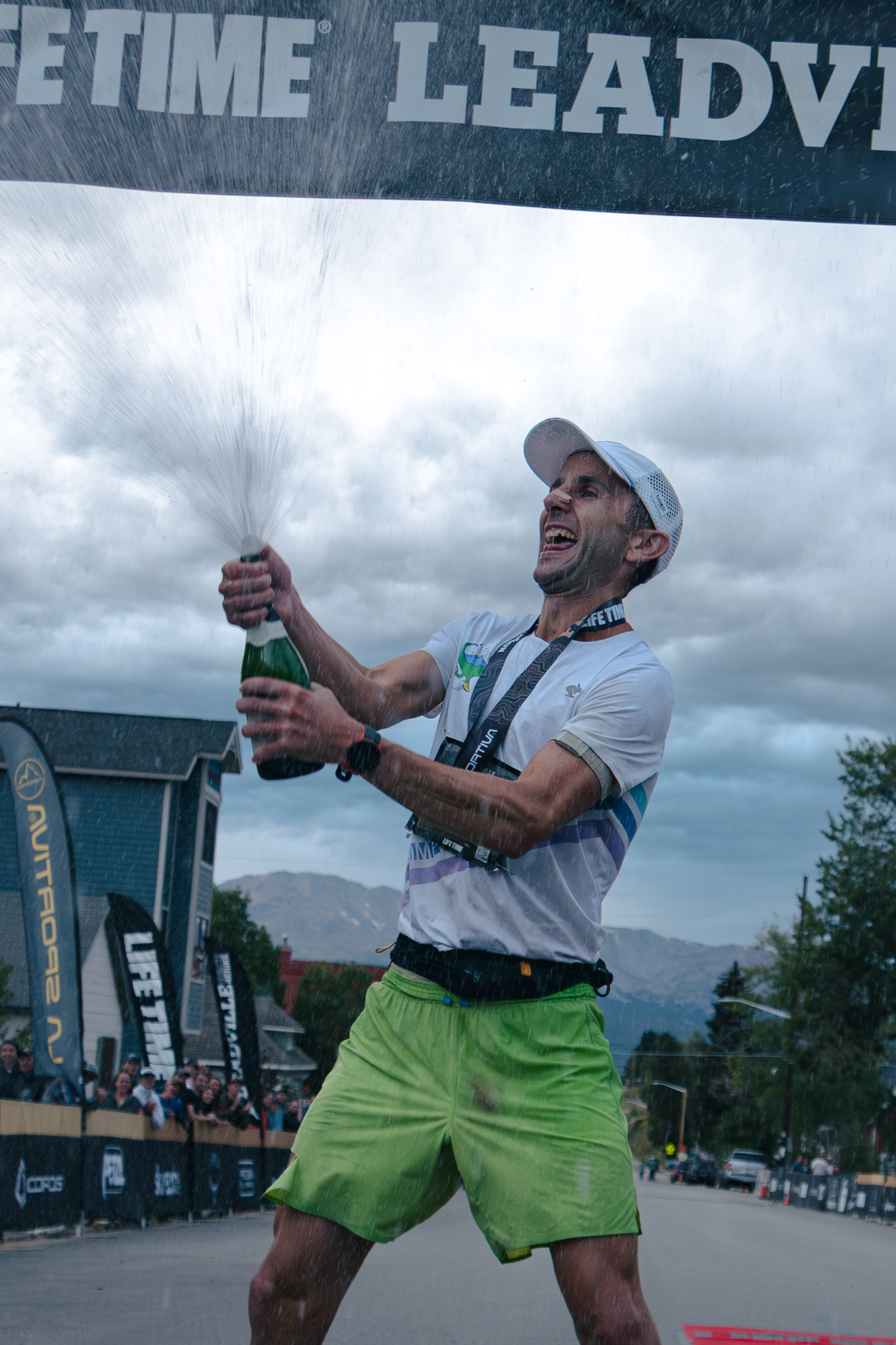 David Roche sprays a bottle of champagne after winning the Leadville 100