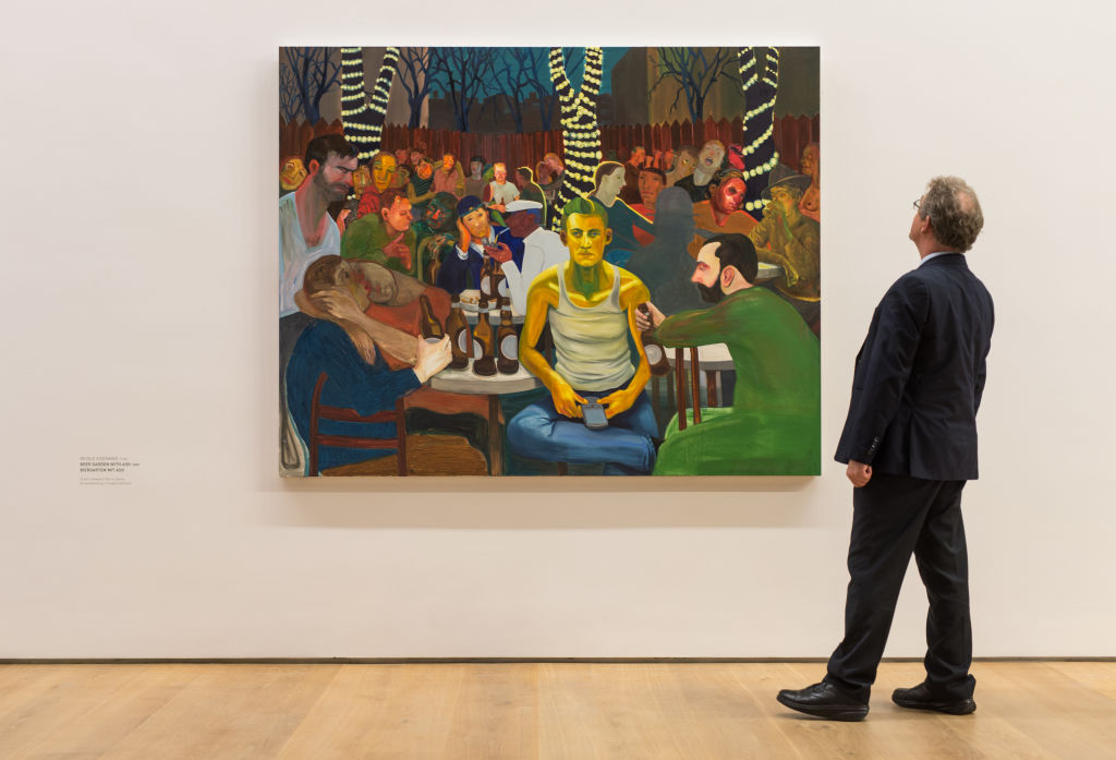 A man looks at the oil painting "Beer Garden with A.K." (2009) by Nicole Eisenman