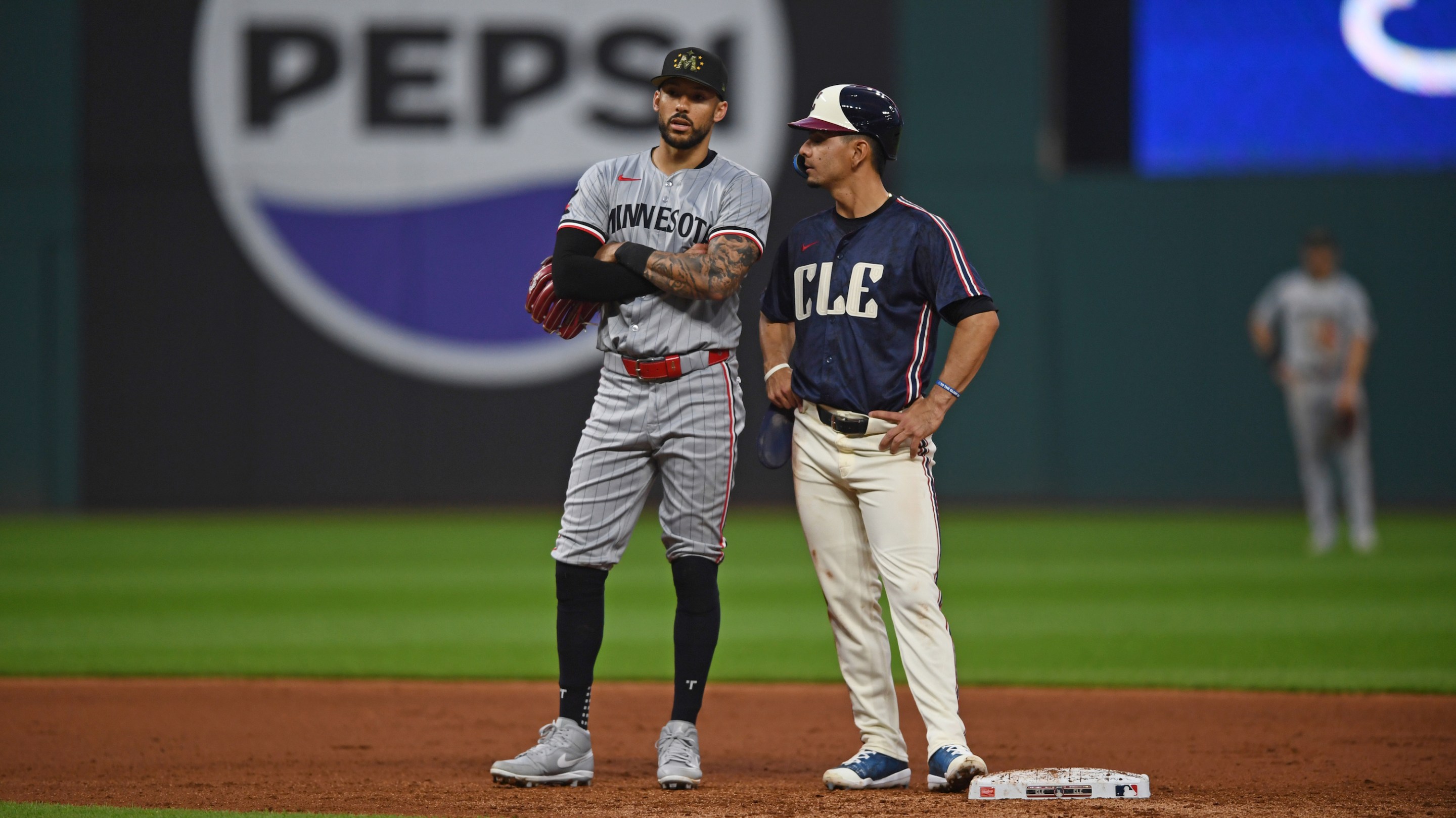 Carlos Correa #4 of the Minnesota Twins and Andrés Giménez #0 of the Cleveland Guardians talk as they wait for a play review during the sixth inning at Progressive Field on May 17, 2024 in Cleveland, Ohio.