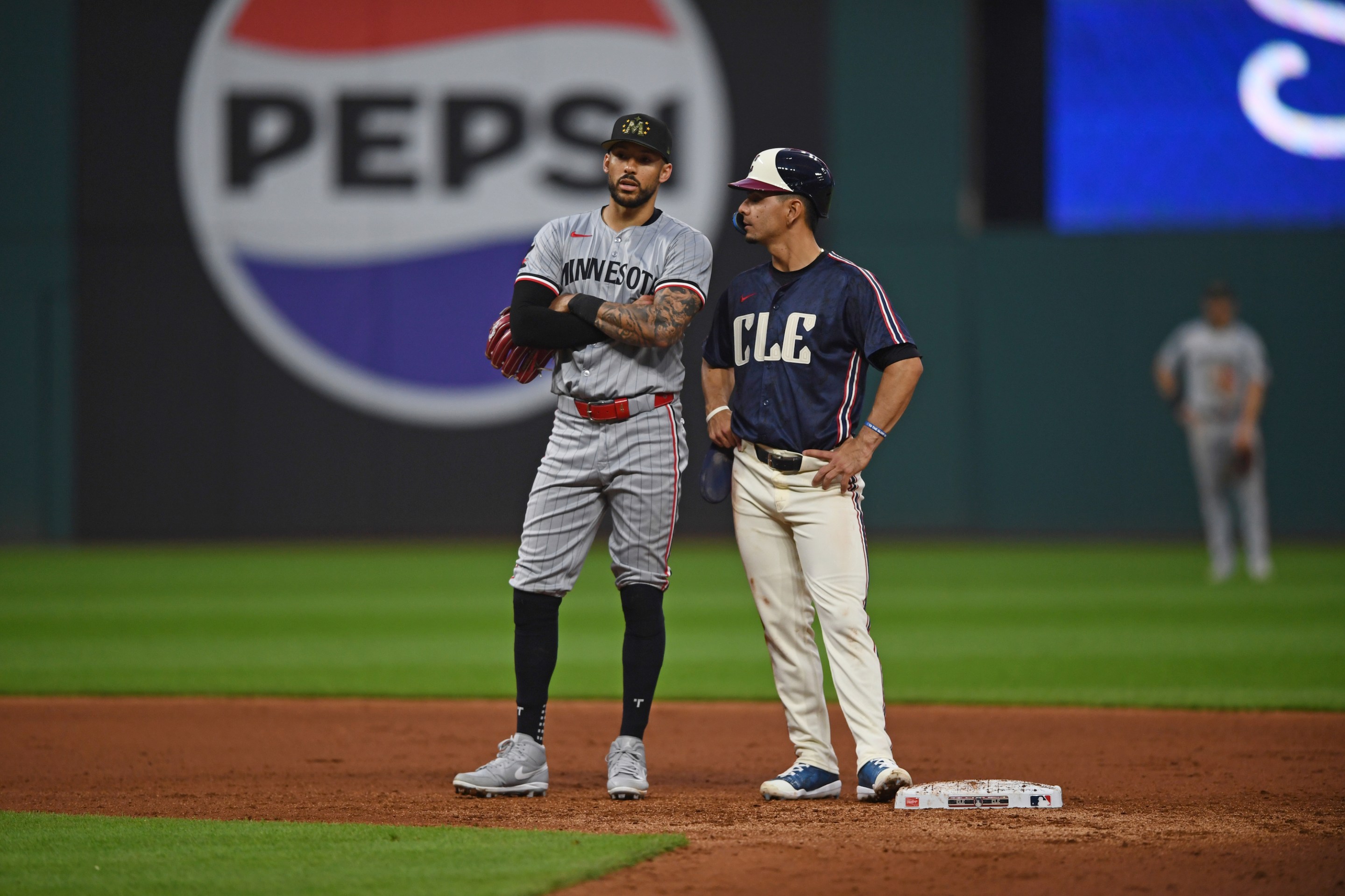 Carlos Correa #4 of the Minnesota Twins and Andrés Giménez #0 of the Cleveland Guardians talk as they wait for a play review during the sixth inning at Progressive Field on May 17, 2024 in Cleveland, Ohio.