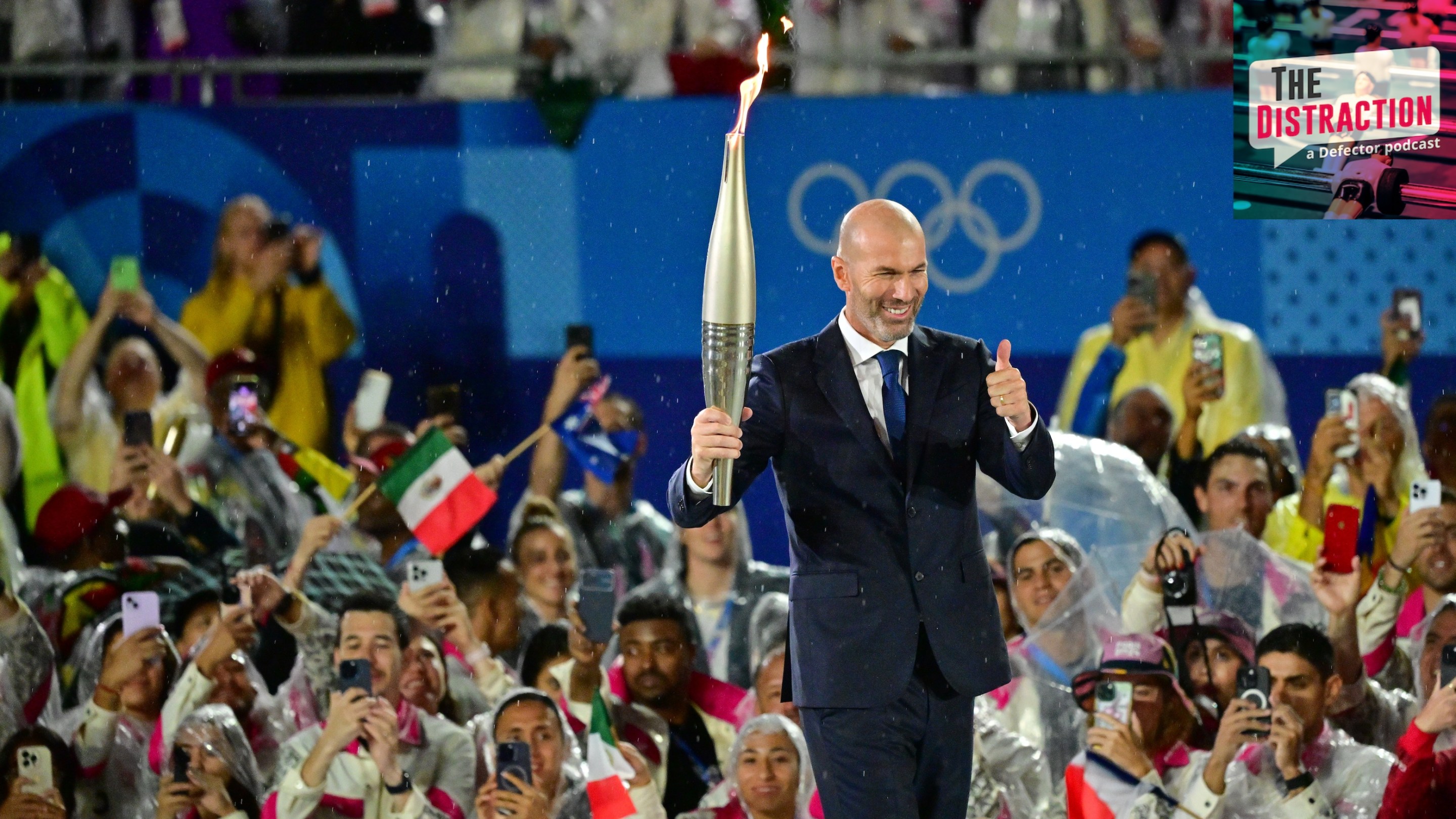 Former footballer Zinedine Zidane carries the torch during the Opening Ceremony of the Olympic Games Paris 2024 on July 26, 2024 in Paris, France. during the Opening Ceremony of the Olympic Games Paris.