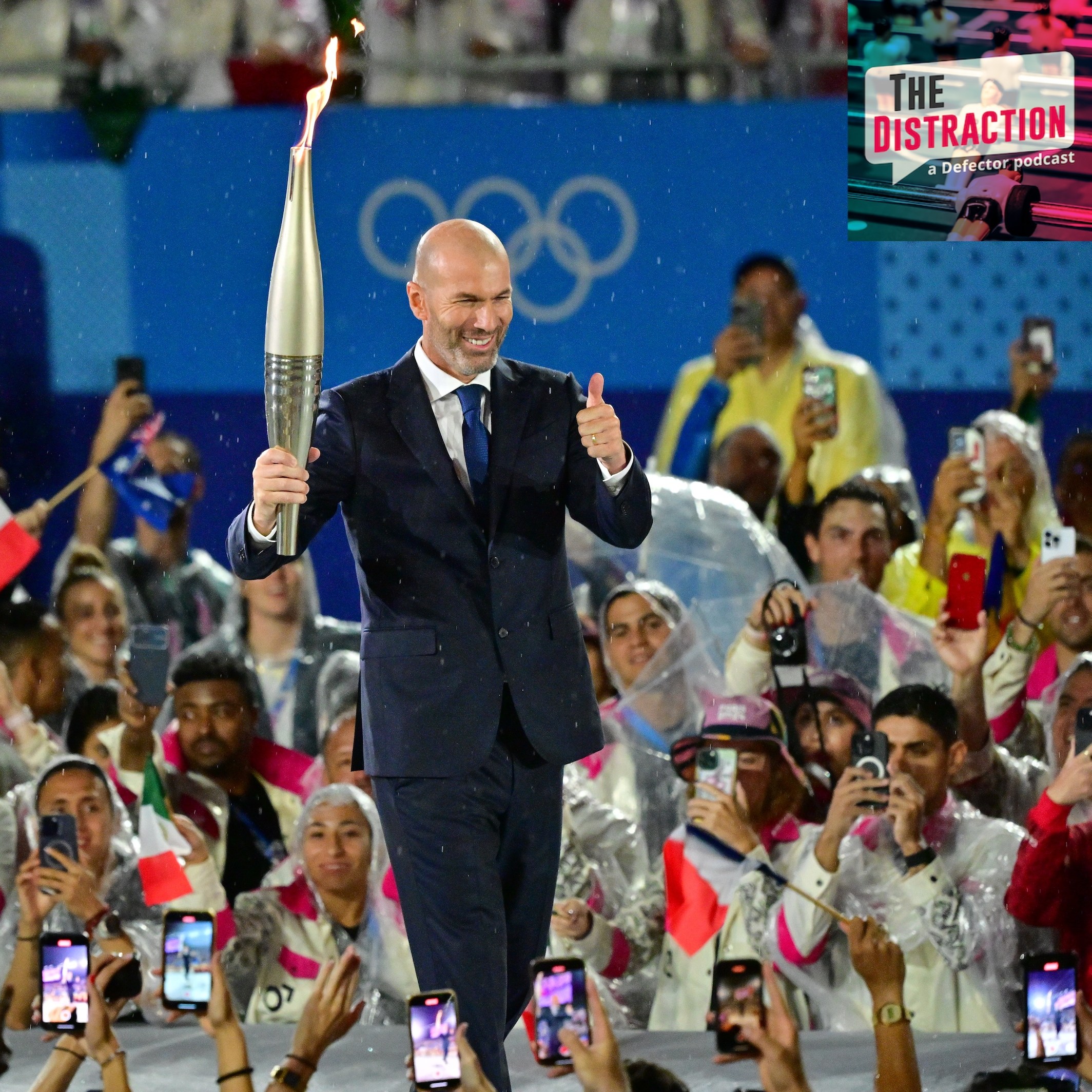 Former footballer Zinedine Zidane carries the torch during the Opening Ceremony of the Olympic Games Paris 2024 on July 26, 2024 in Paris, France. during the Opening Ceremony of the Olympic Games Paris.