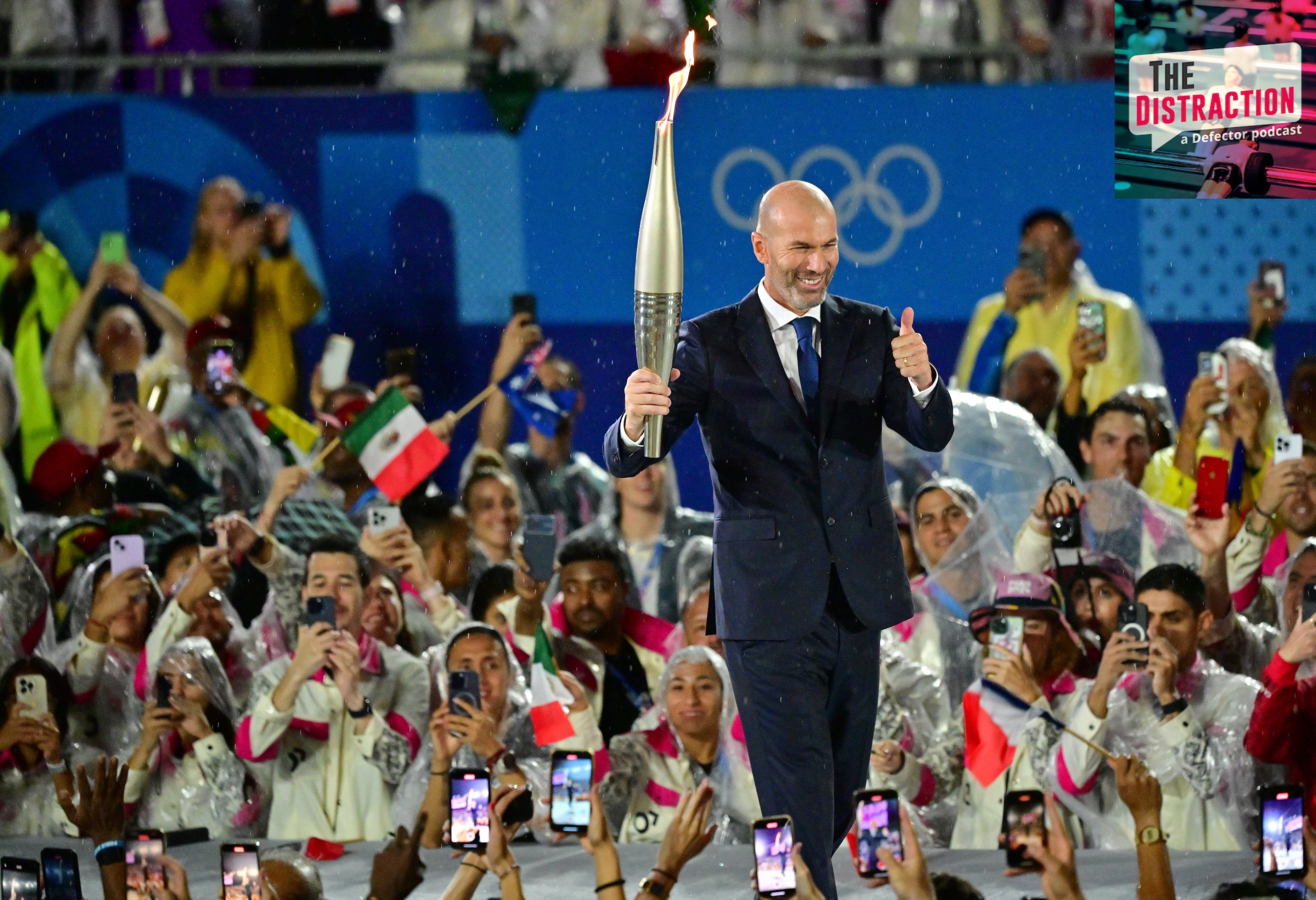 Former footballer Zinedine Zidane carries the torch during the Opening Ceremony of the Olympic Games Paris 2024 on July 26, 2024 in Paris, France. during the Opening Ceremony of the Olympic Games Paris.