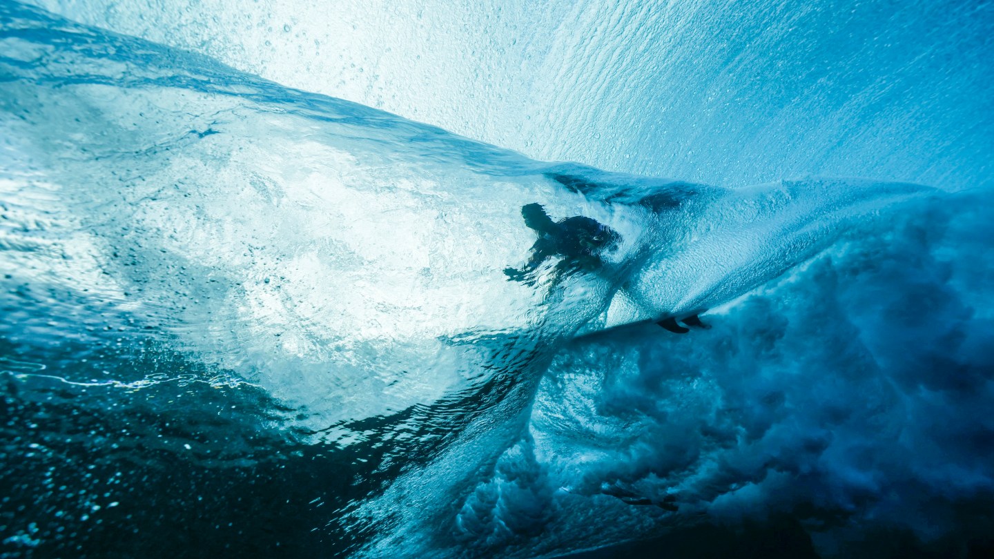 TOPSHOT - France's Joan Duru gets into the barrel in the 2nd heat of the men's surfing round 1, during the Paris 2024 Olympic Games, in Teahupo'o, on the French Polynesian Island of Tahiti, on July 27, 2024.