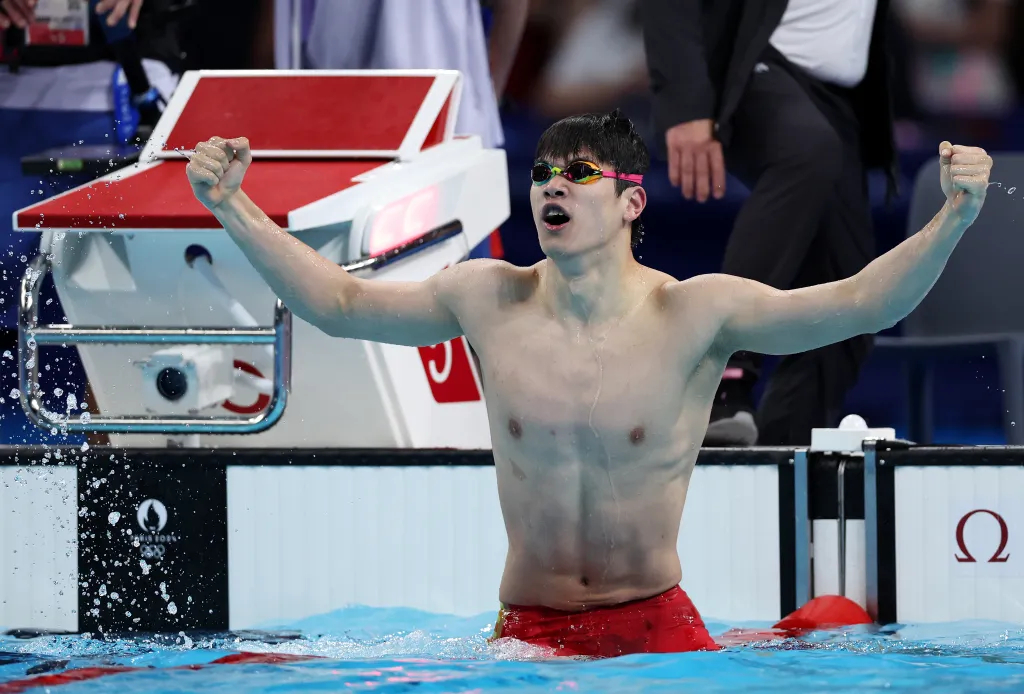 NANTERRE, FRANCE - JULY 31: Zhanle Pan of Team People's Republic of China celebrates after winning gold in a world record time in the Men's 100m Freestyle Final on day five of the Olympic Games Paris 2024 at Paris La Defense Arena on July 31, 2024 in Nanterre, France.