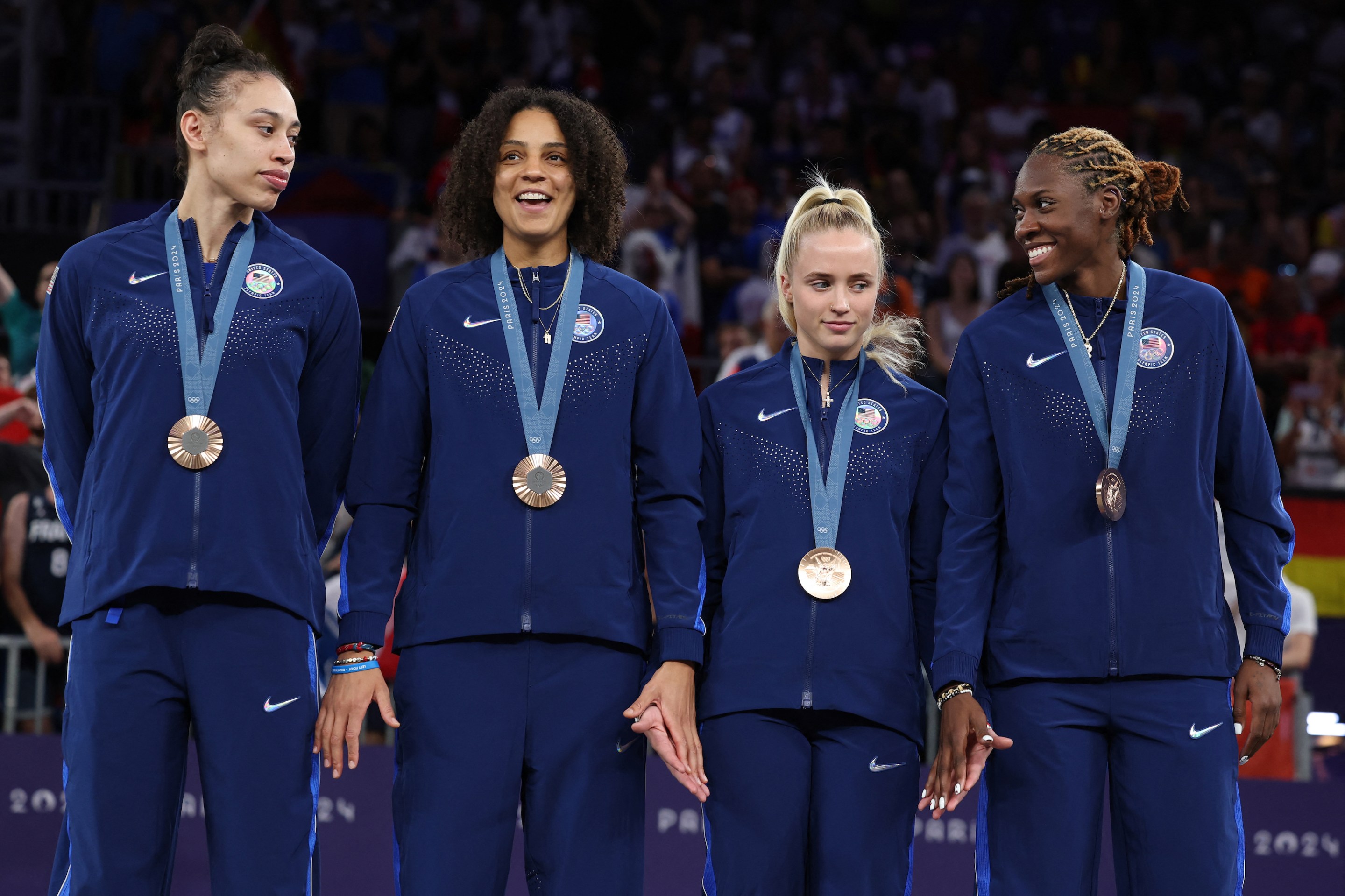 Bronze medallists USA celebrate on the podium of the women's 3x3 basketball during the Paris 2024 Olympic Games at La Concorde in Paris on August 5, 2024.