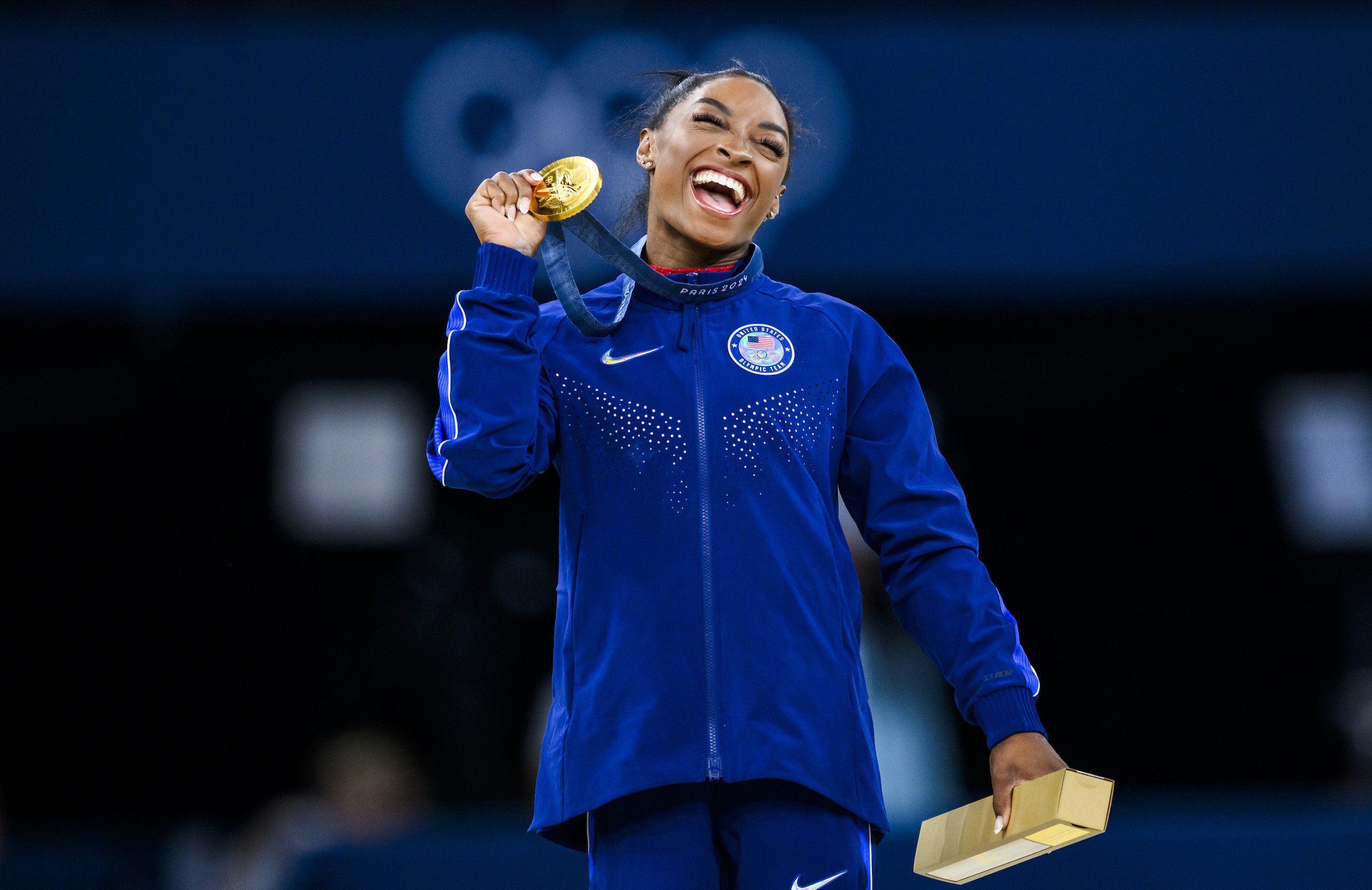 Simone Biles holds up her gold medal in vault at the 2024 Olympics