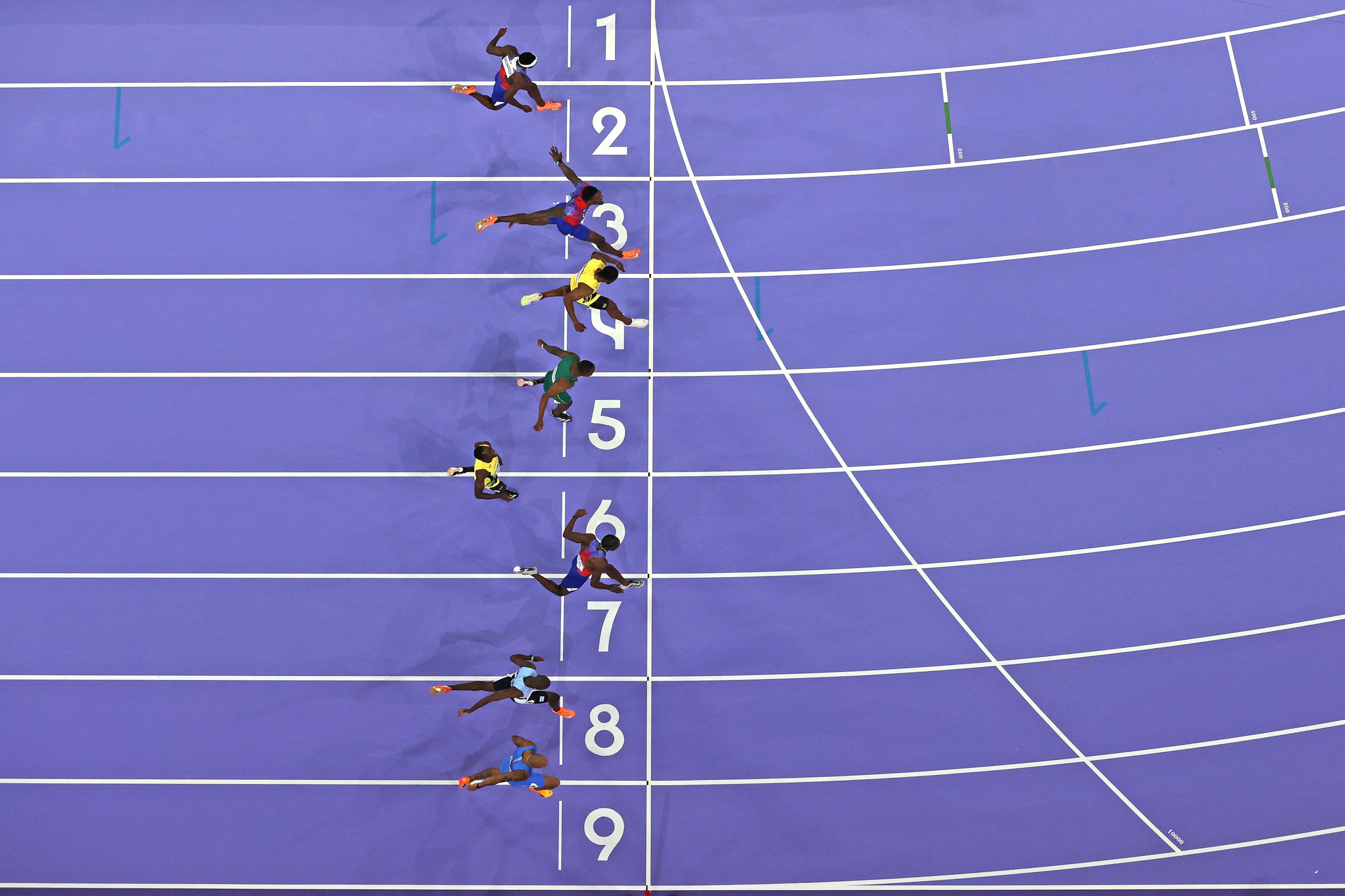 A photo finish of the 100-meter at the 2024 Olympics, with Noah Lyles winning.