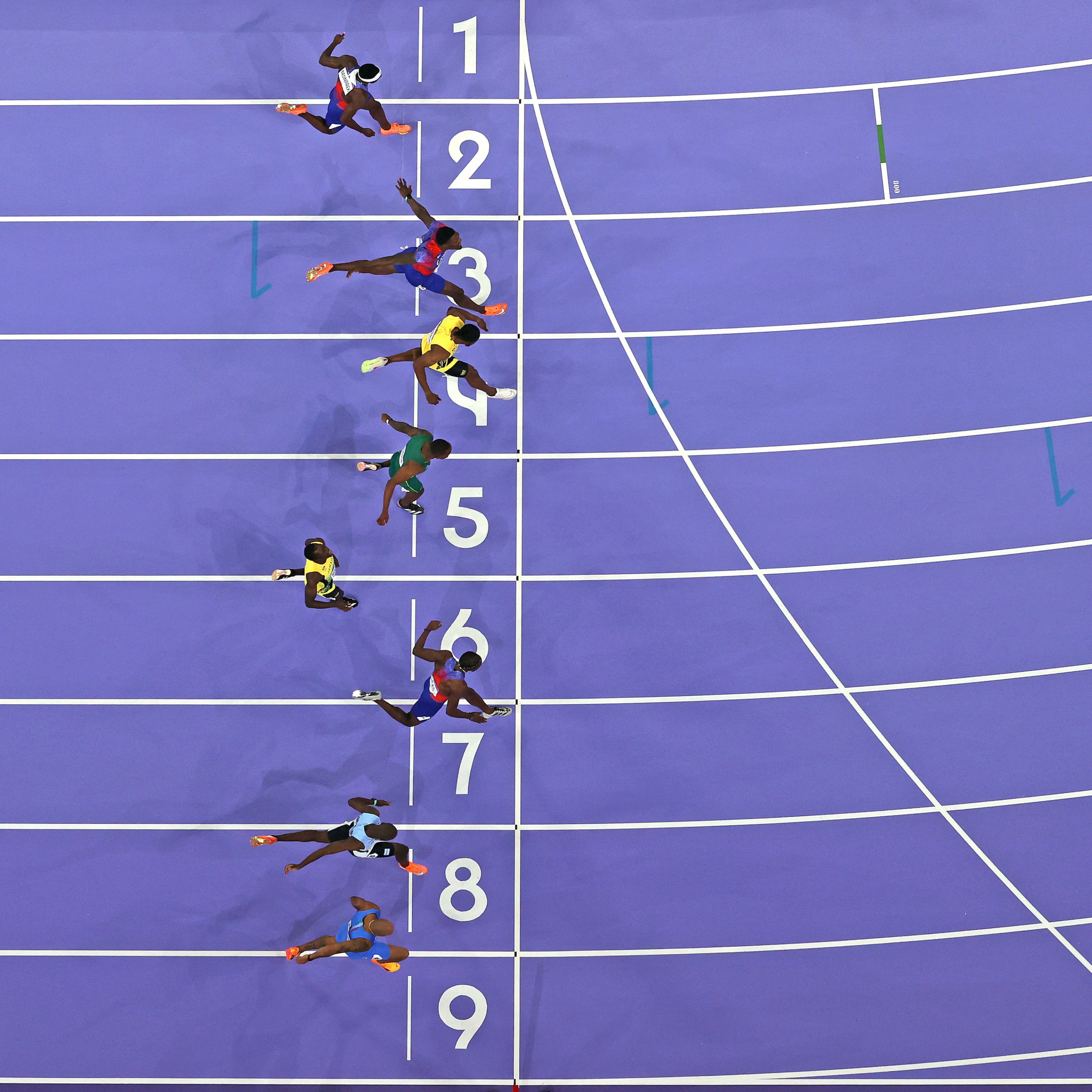 A photo finish of the 100-meter at the 2024 Olympics, with Noah Lyles winning.