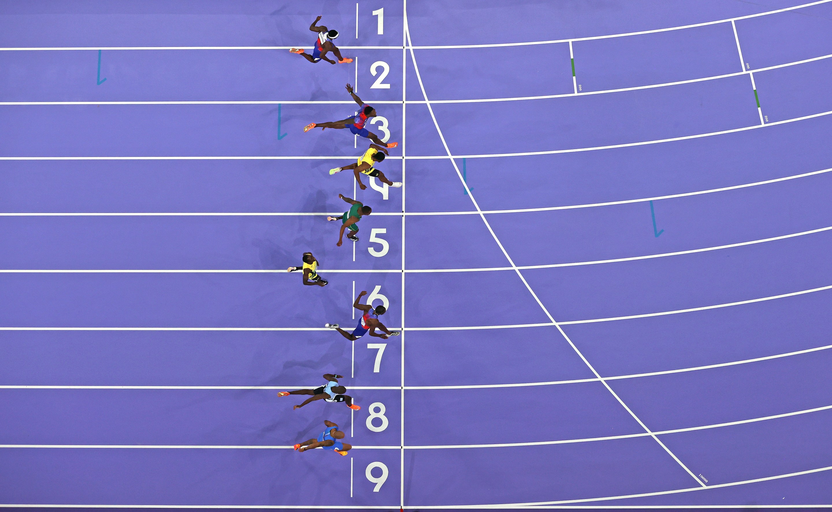 A photo finish of the 100-meter at the 2024 Olympics, with Noah Lyles winning.