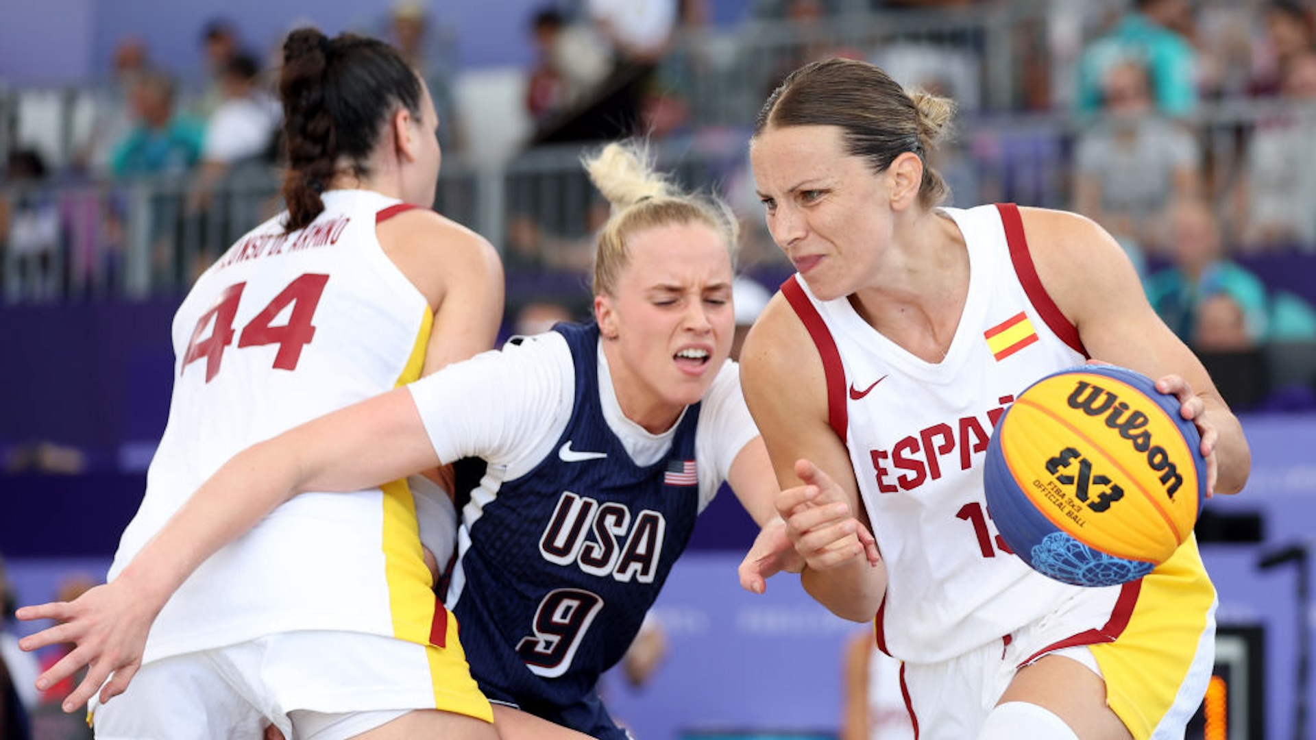 Hailey van Lith #9 of Team United States attempts to fight past a screen by Gracia Alonso #44 of Team Spain while Sandra Ygueravide #13 of Team Spain drives past during a Women's 3x3 basketball semifinal game between the United States and Spain on day ten of the Olympic Games Paris 2024 at Esplanade Des Invalides on August 05, 2024 in Paris, France.