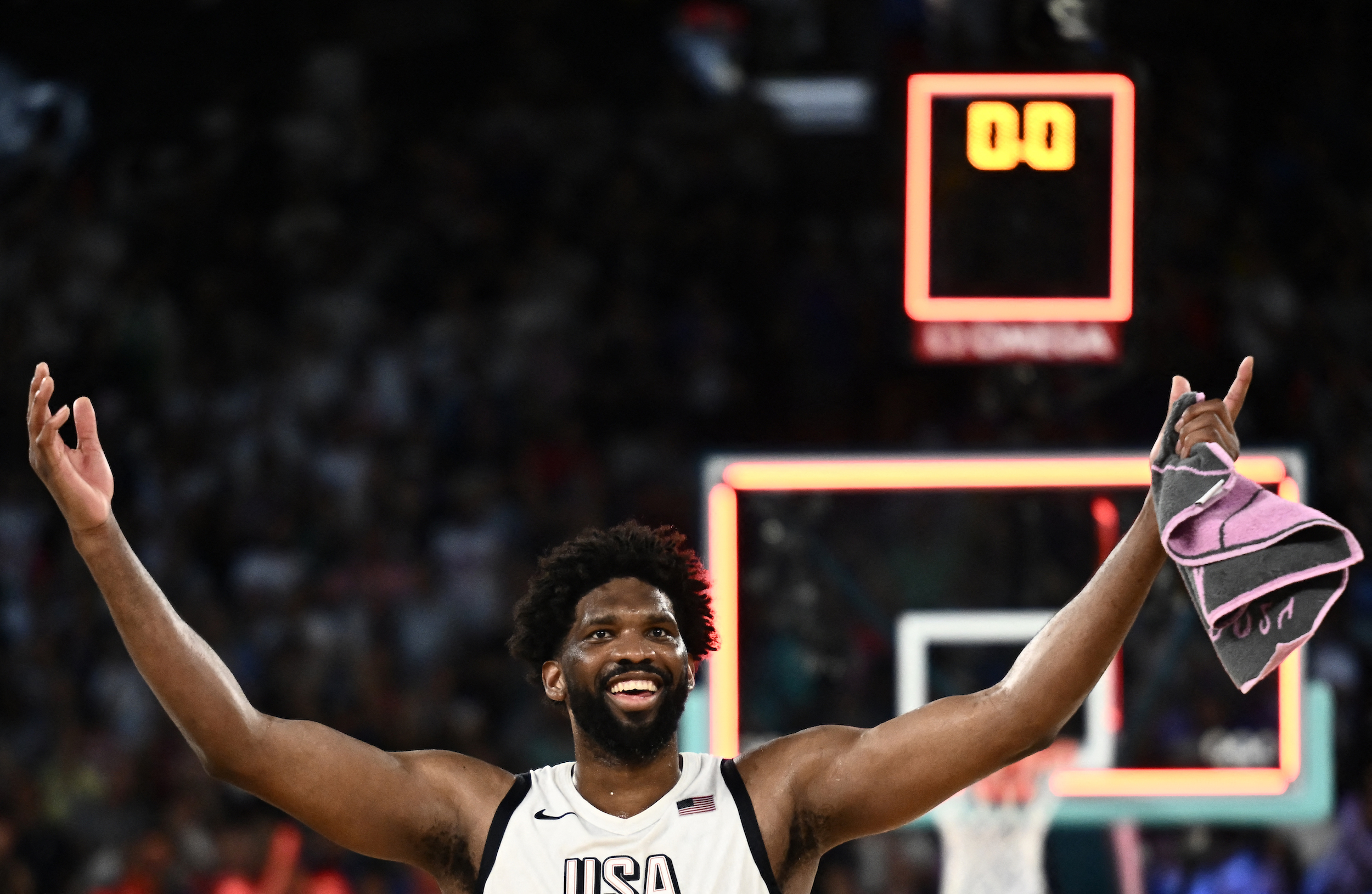 USA's #11 Joel Embiid celebrates at the end of the men's semifinal basketball match between USA and Serbia during the Paris 2024 Olympic Games at the Bercy Arena in Paris on August 8, 2024. (Photo by Aris MESSINIS / AFP)