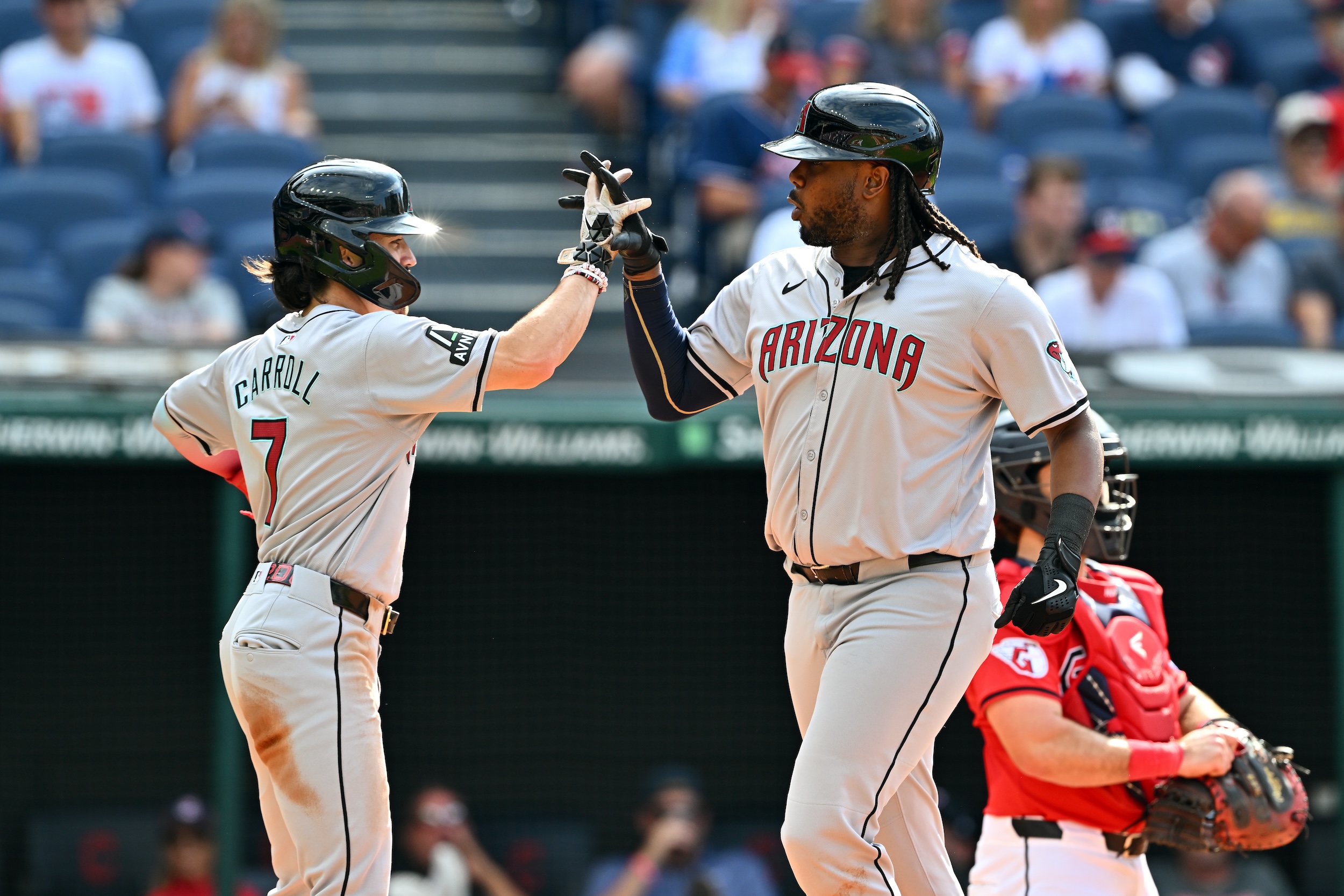 Josh Bell and Corbin Carroll high-five.