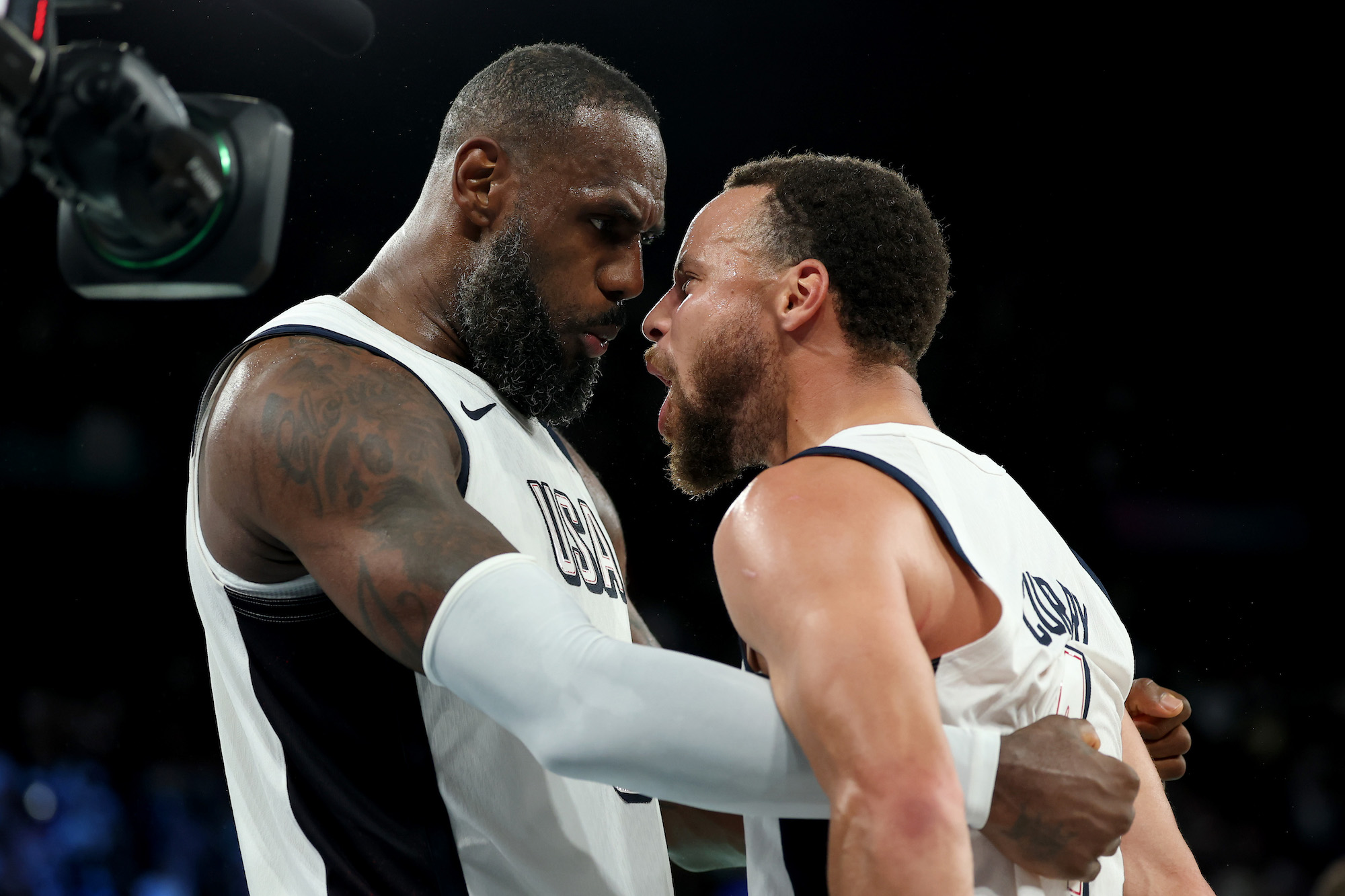 PARIS, FRANCE - AUGUST 08: Lebron James #6 and Stephen Curry #4 of Team United States celebrate after their team's win against Team Serbia during a Men's basketball semifinals match between Team United States and Team Serbia on day thirteen of the Olympic Games Paris 2024 at Bercy Arena on August 08, 2024 in Paris, France. (Photo by Gregory Shamus/Getty Images)