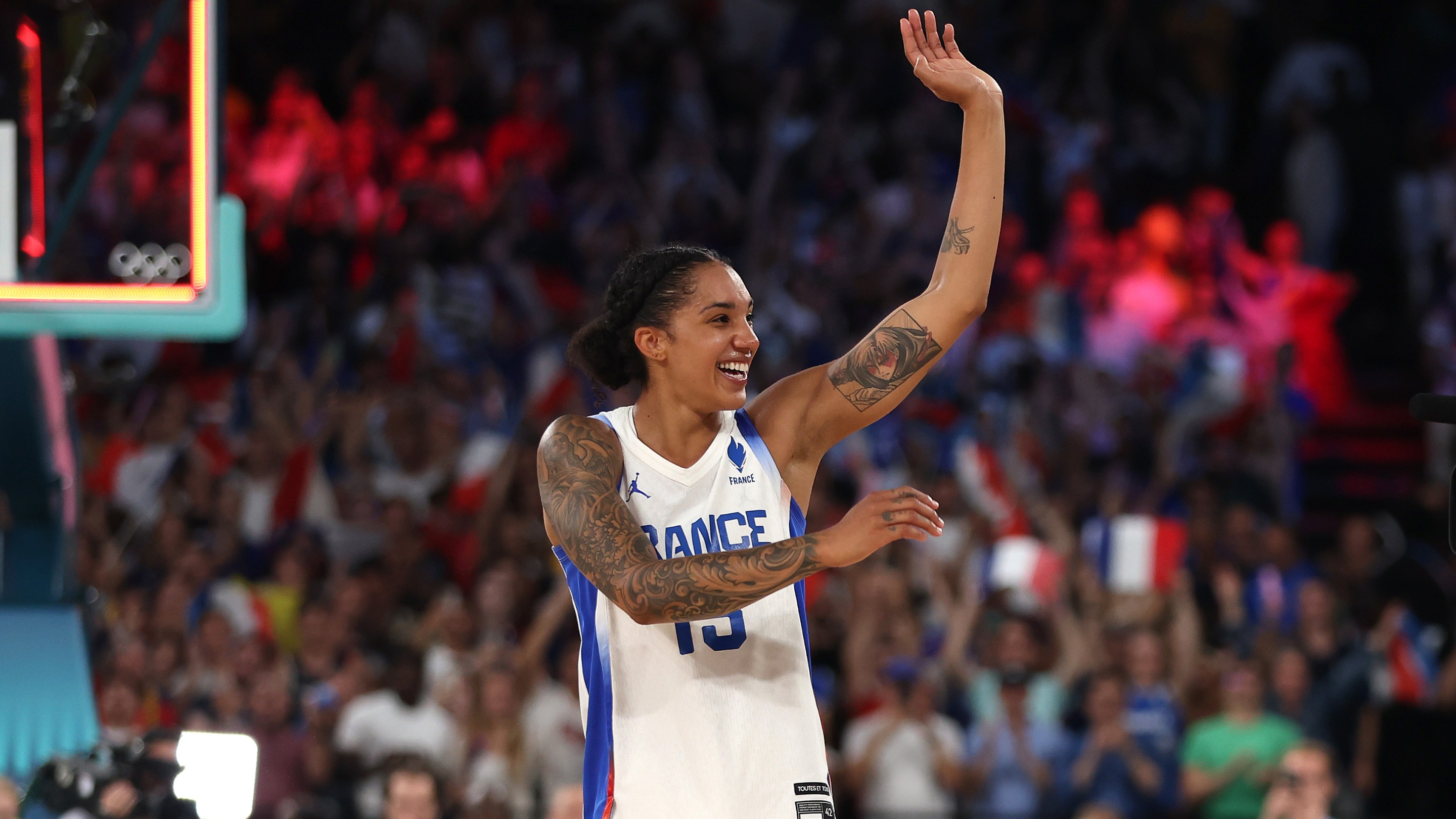 Gabby Williams #15 of Team France waves to the crowd after her team's victory against Team Belgium during a women's semifinal match between Team France and Team Belgium on day fourteen of the Olympic Games Paris 2024 at Bercy Arena on August 09, 2024 in Paris, France.