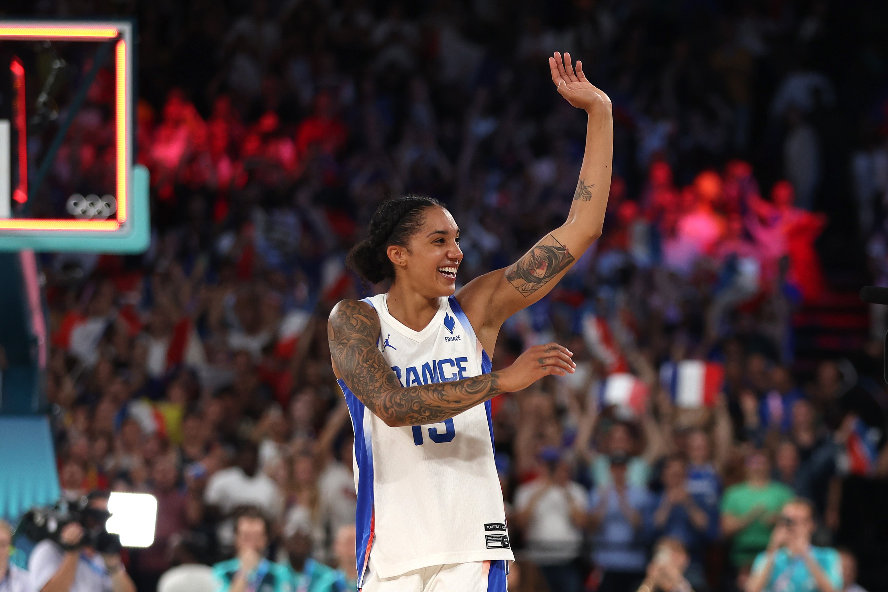 Gabby Williams #15 of Team France waves to the crowd after her team's victory against Team Belgium during a women's semifinal match between Team France and Team Belgium on day fourteen of the Olympic Games Paris 2024 at Bercy Arena on August 09, 2024 in Paris, France.