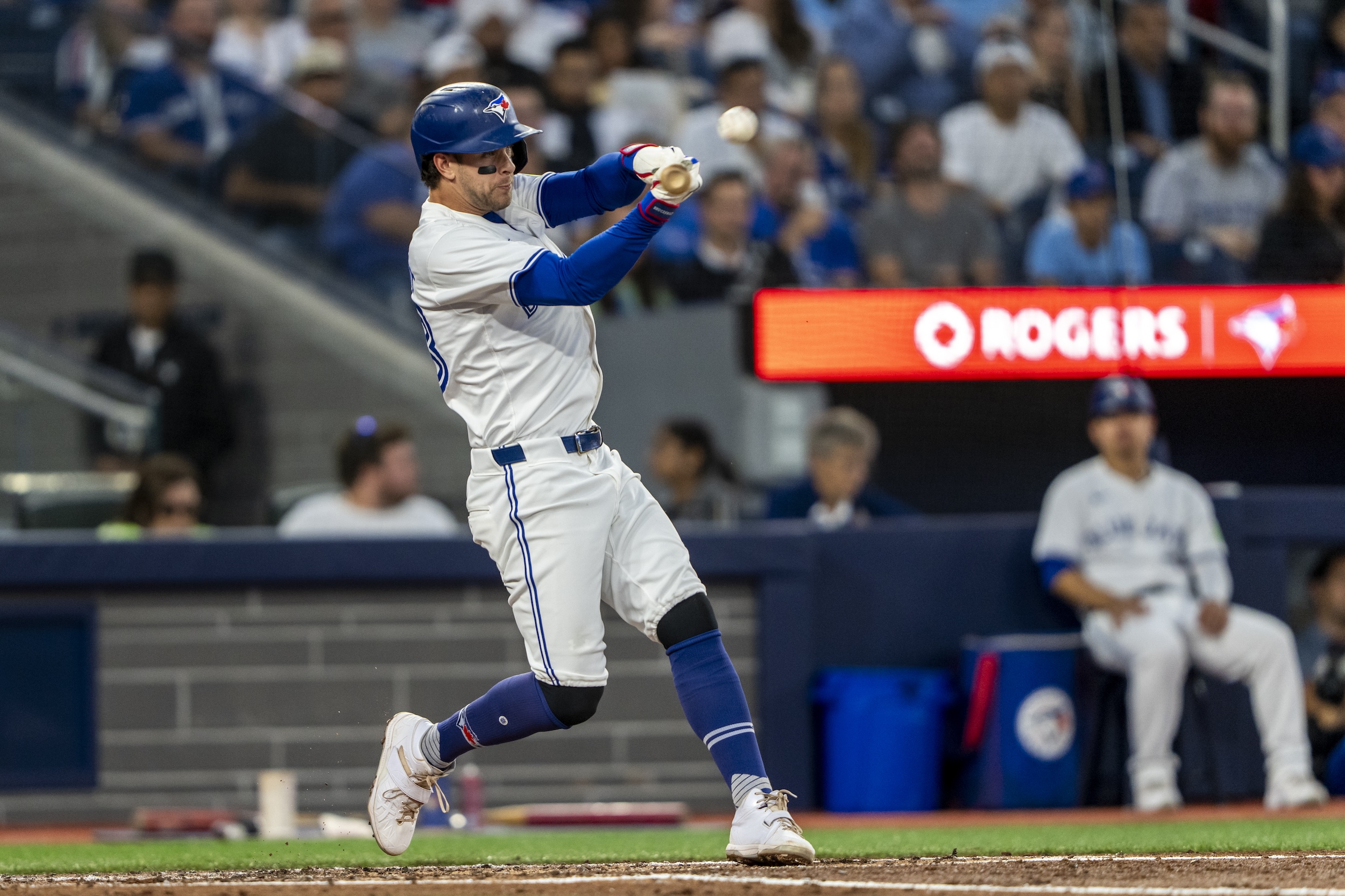 Ernie Clement slugs a home run on a pitch at forehead height.