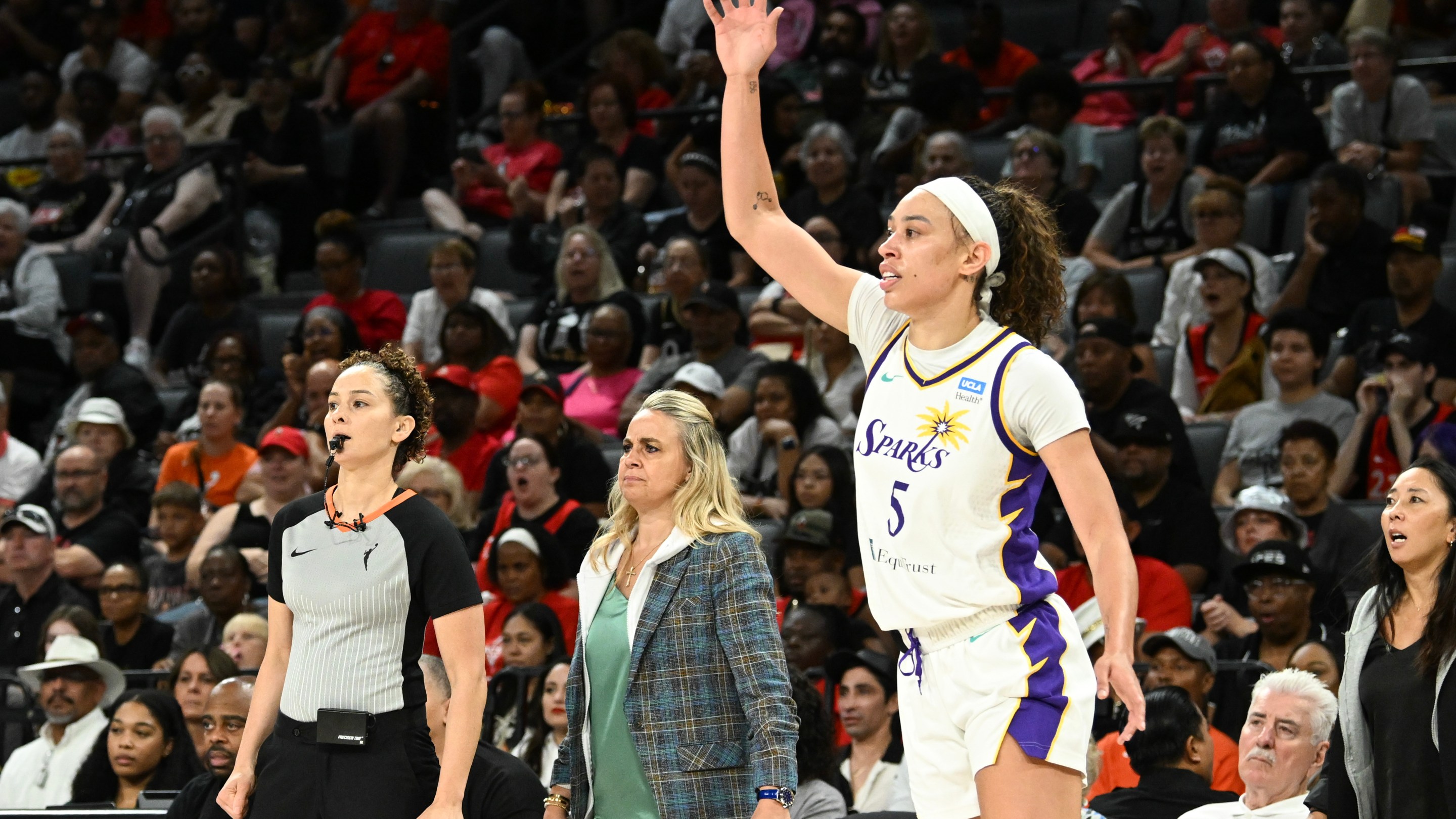 Head coach Becky Hammon of the Las Vegas Aces and Dearica Hamby #5 of the Los Angeles Sparks look on during the first half at Michelob ULTRA Arena on August 18, 2024 in Las Vegas, Nevada.