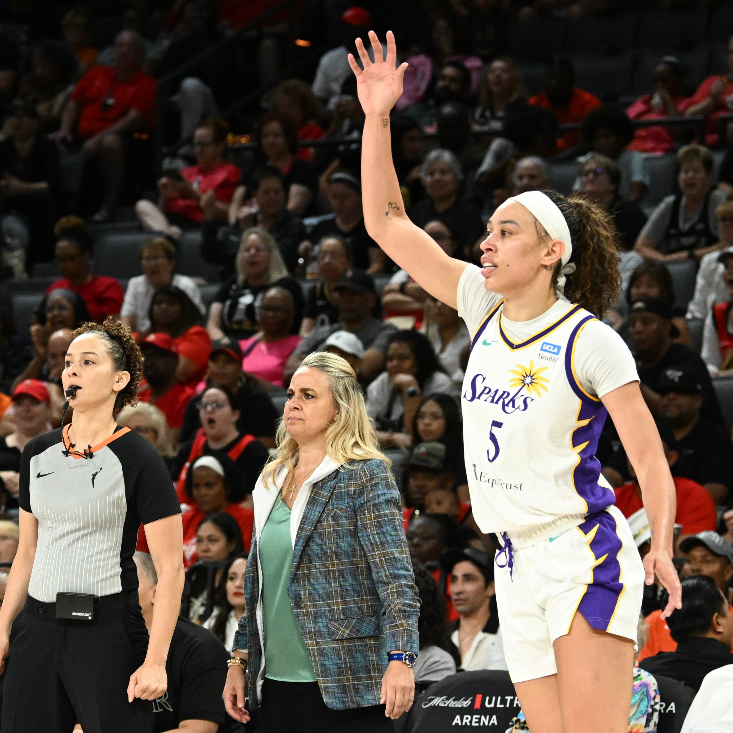 Head coach Becky Hammon of the Las Vegas Aces and Dearica Hamby #5 of the Los Angeles Sparks look on during the first half at Michelob ULTRA Arena on August 18, 2024 in Las Vegas, Nevada.