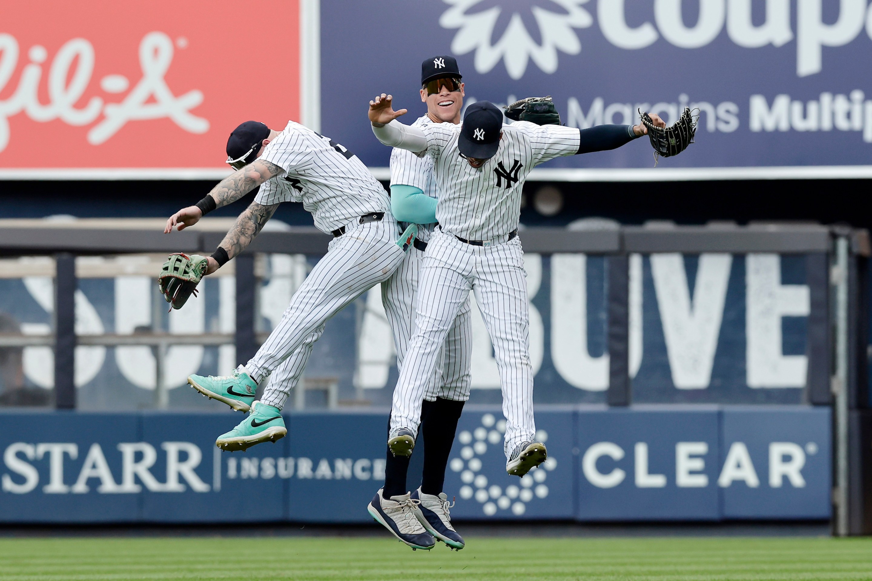 NEW YORK, NEW YORK - AUGUST 25: (L-R) Alex Verdugo #24, Aaron Judge #99 and Juan Soto #22 of the New York Yankees celebrate after defeating the Colorado Rockies at Yankee Stadium on August 25, 2024 in New York City. The Yankees defeated the Rockies 10-3. (Photo by Jim McIsaac/Getty Images)