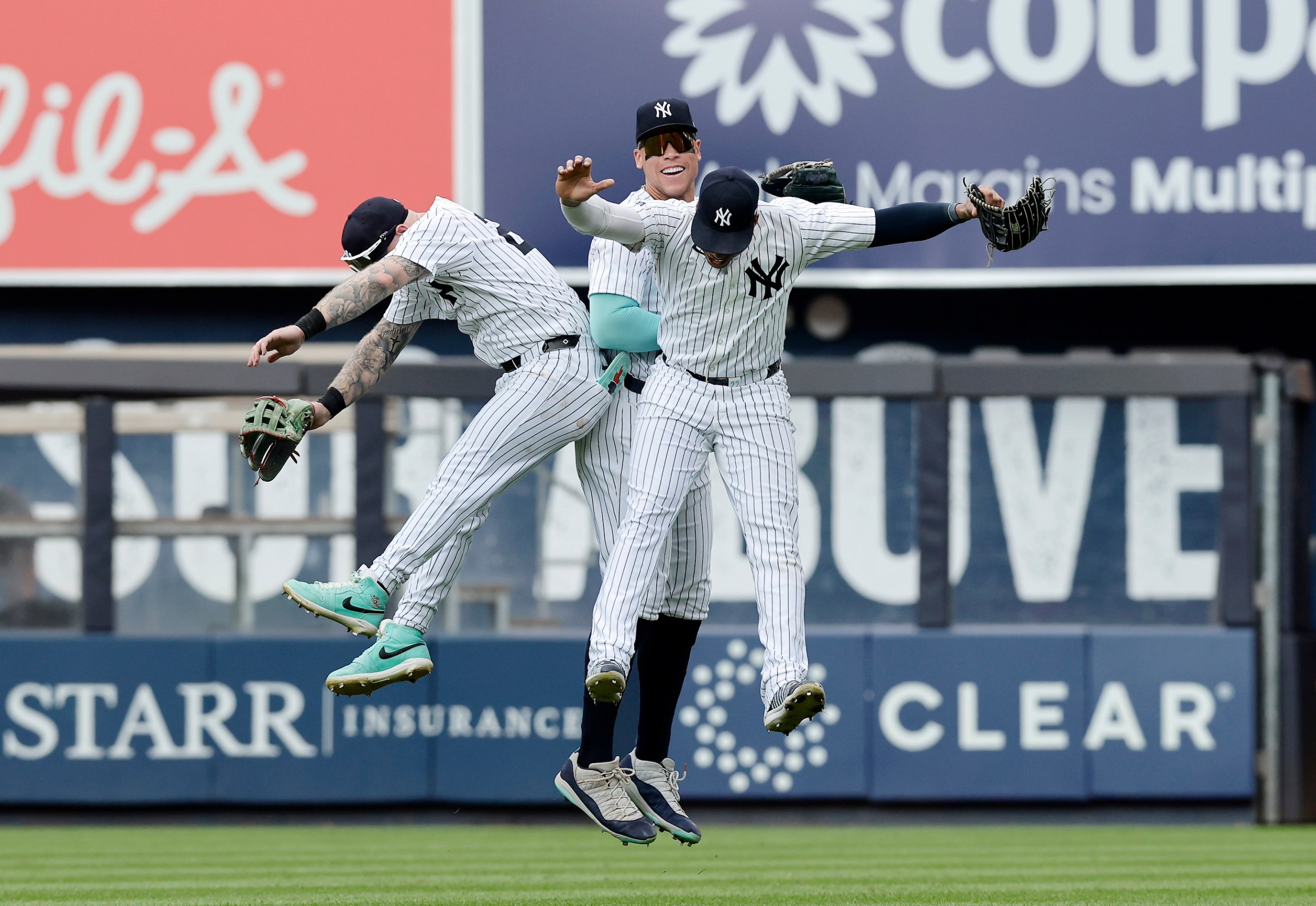 NEW YORK, NEW YORK - AUGUST 25: (L-R) Alex Verdugo #24, Aaron Judge #99 and Juan Soto #22 of the New York Yankees celebrate after defeating the Colorado Rockies at Yankee Stadium on August 25, 2024 in New York City. The Yankees defeated the Rockies 10-3. (Photo by Jim McIsaac/Getty Images)