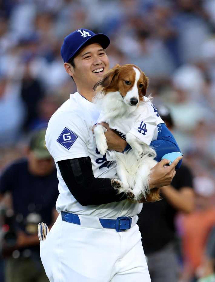 Shohei Ohtani holds Decoy in his arms.