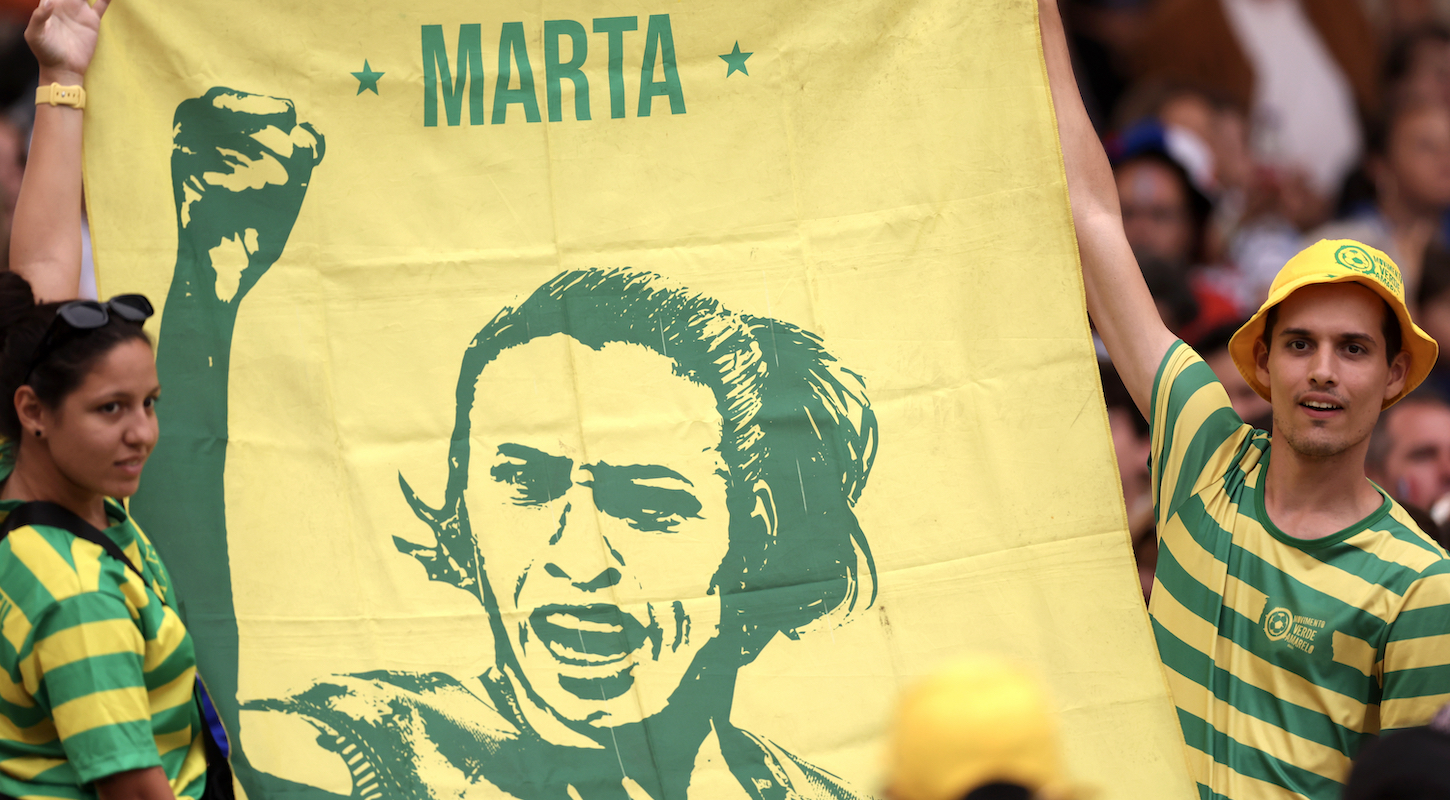 ans of Team Brazil hold a flag with a picture of Marta prior to the Women's Quarterfinal match between France and Brazil during the Olympic Games Paris 2024.