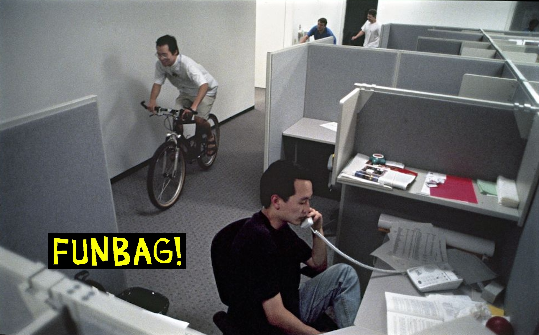 Eric Ng leads the parade through the cubicles at Yahoo! in Sunnyvale, Calif. on May 24, 1996. Co-workers follow on bikes and roller blades. The parade was a regular, though impromptu, event at Yahoo!