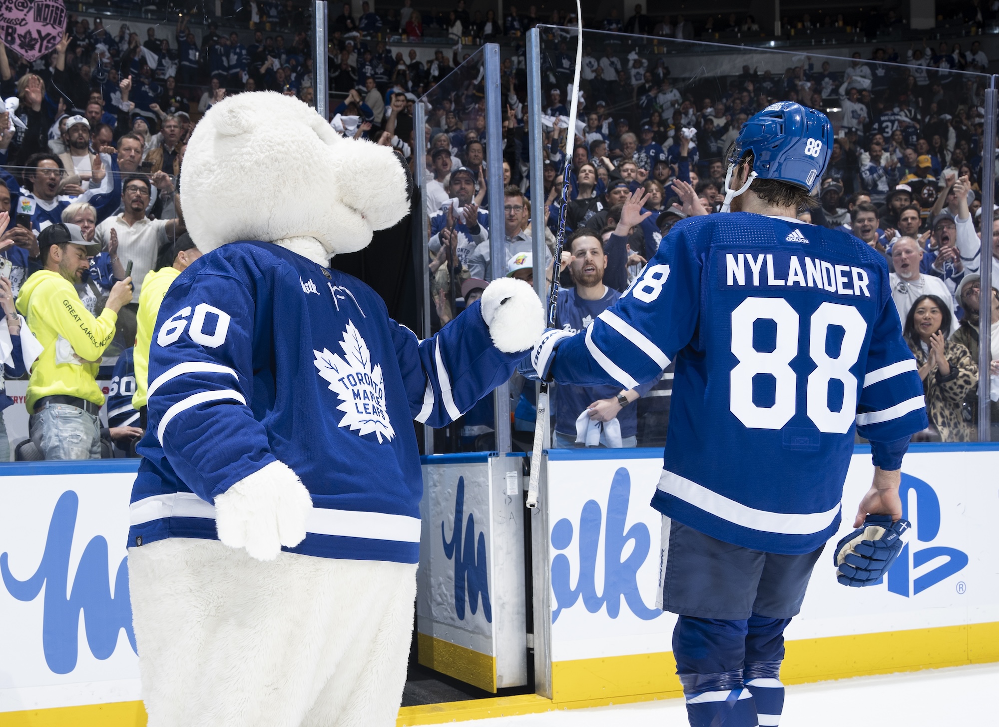 TORONTO, ON - MAY 2: William Nylander #88 of the Toronto Maple Leafs celebrates with mascot Carlton the Bear after defeating the Boston Bruins in Game Six of the First Round of the 2024 Stanley Cup Playoffs at Scotiabank Arena on May 2, 2024 in Toronto, Ontario, Canada. (Photo by Mark Blinch/NHLI via Getty Images)