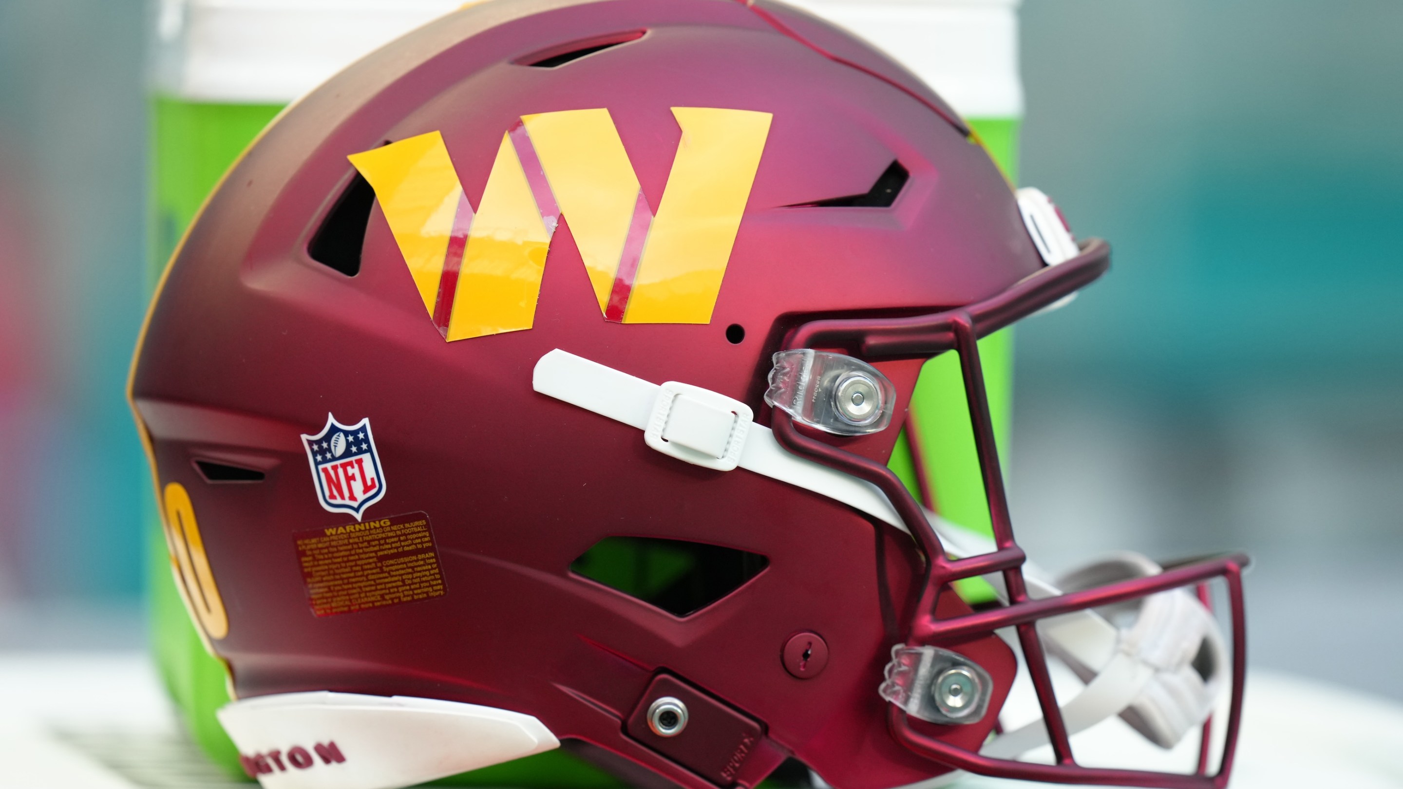 a Washington Commanders helmet rests near the sidelines during the game between the Washington Commanders and the Miami Dolphins on Saturday, August 17, 2024 at Hard Rock Stadium in Miami Gardens, Fla.