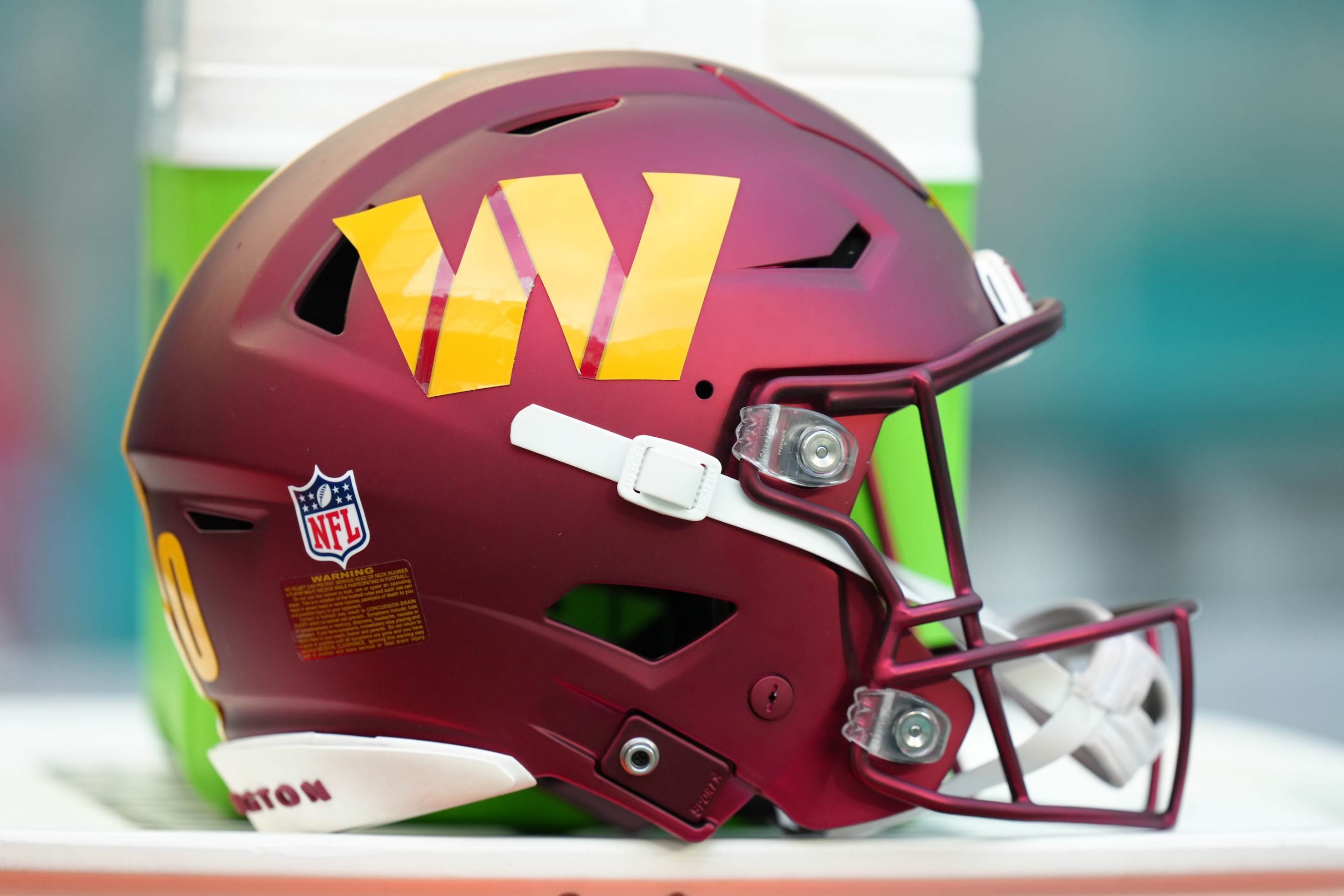 a Washington Commanders helmet rests near the sidelines during the game between the Washington Commanders and the Miami Dolphins on Saturday, August 17, 2024 at Hard Rock Stadium in Miami Gardens, Fla.