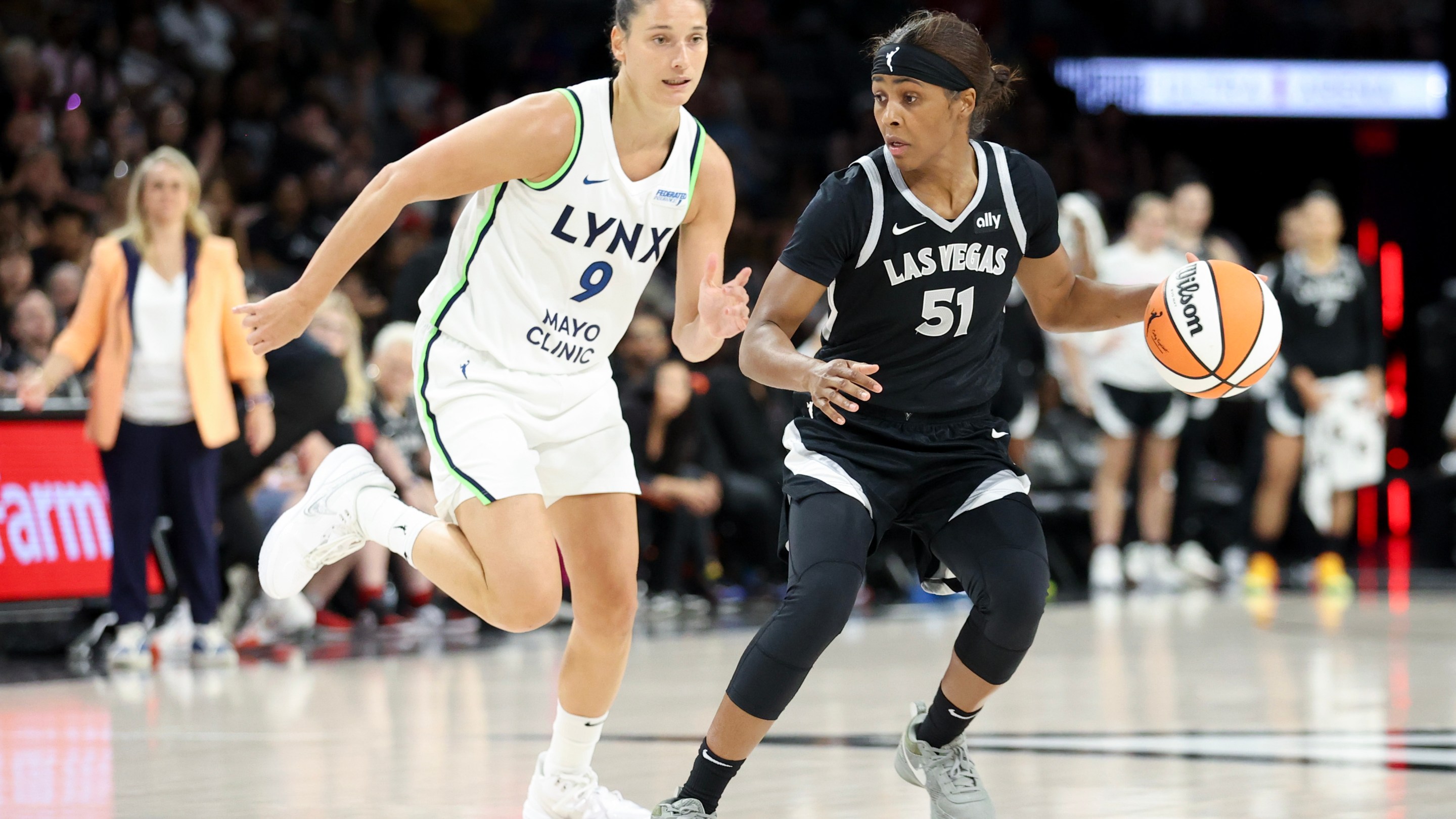 Sydney Colson #51 of the Las Vegas Aces drives against Cecilia Zandalasini #9 of the Minnesota Lynx in the fourth quarter of their game at Michelob ULTRA Arena on August 21, 2024 in Las Vegas, Nevada.