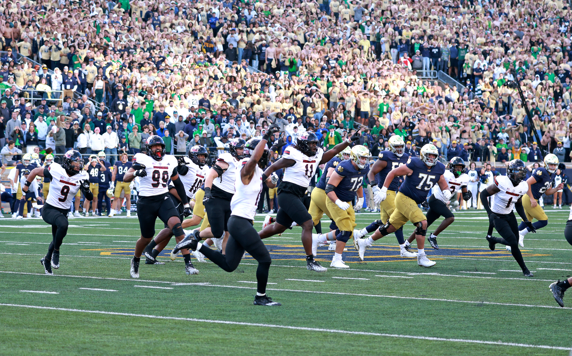 Northern Illinois Huskies players celebrate after an upset win over Notre Dame.