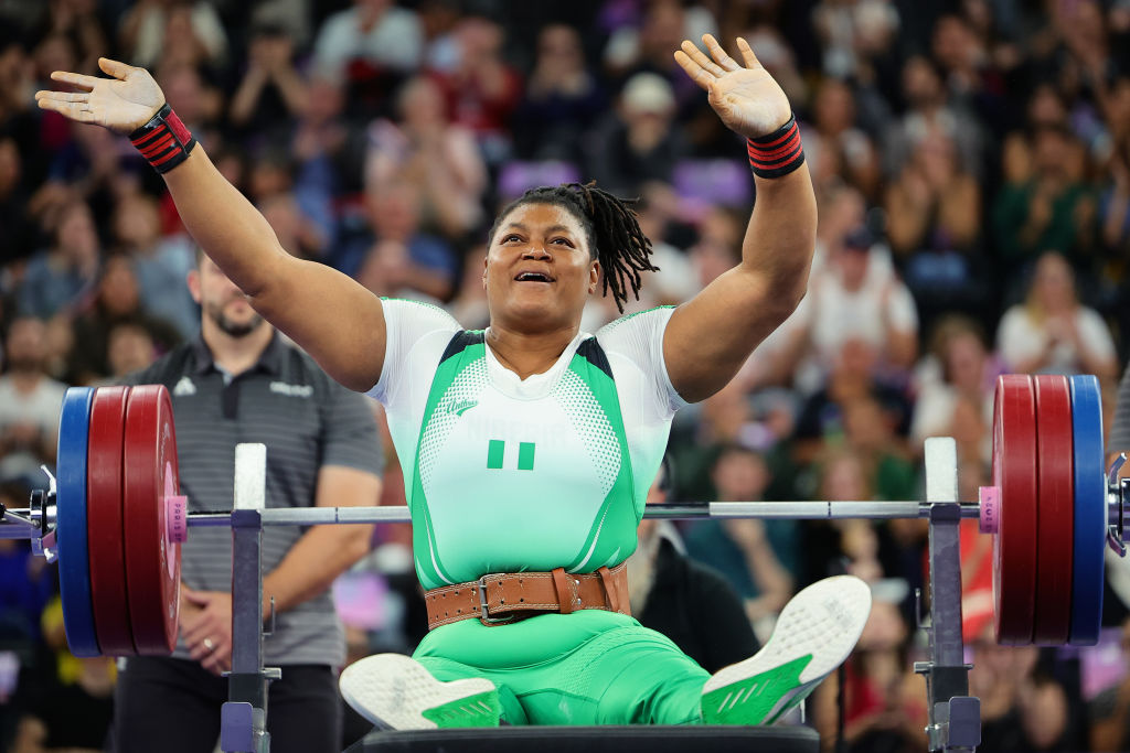 Nigerian powerlifter Folashade Oluwafemiayo waves to the crowd after a record breaking 166kg bench press at the Paris 2024 Summer Paralympic Games.