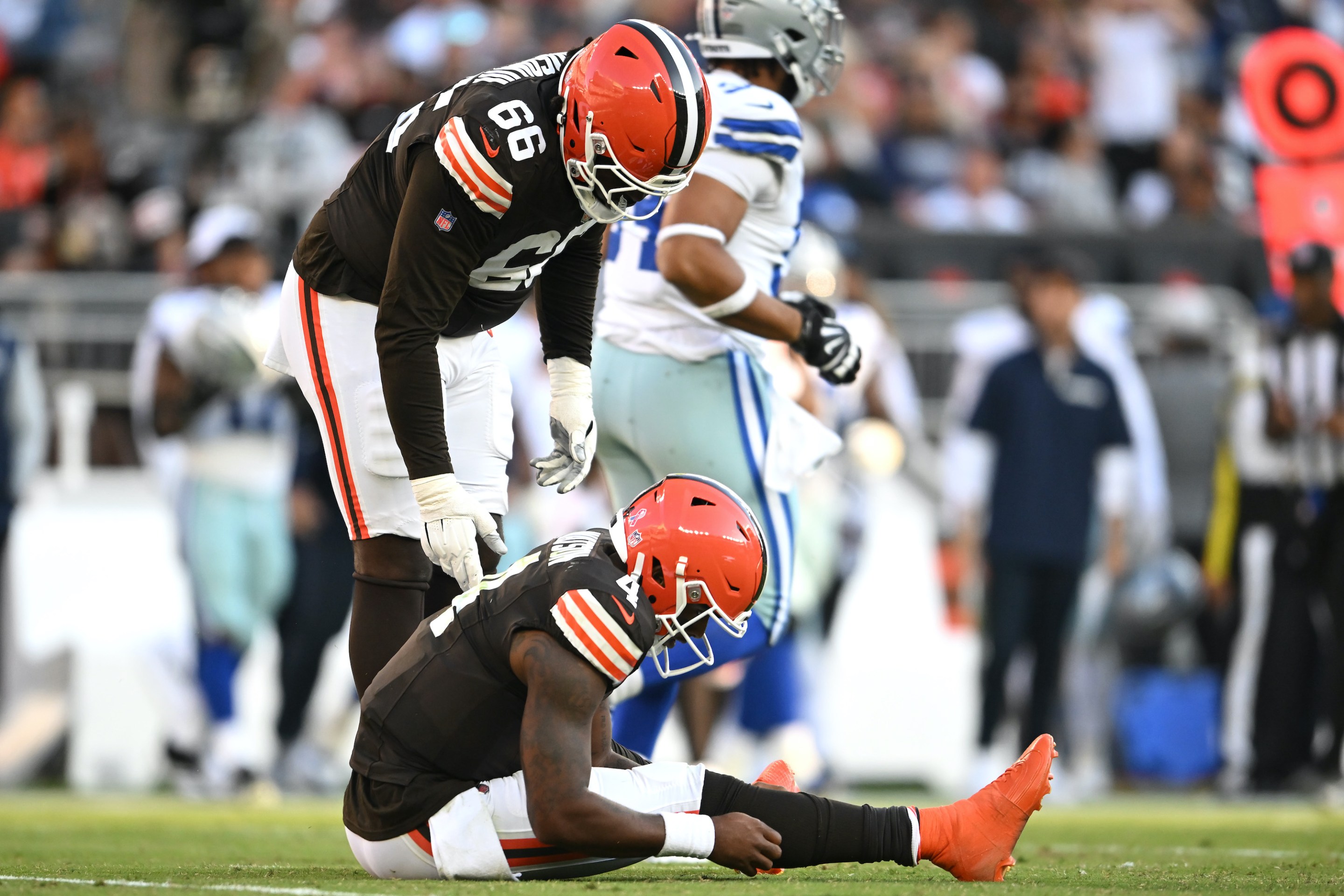 Deshaun Watson sits on the turf during the Browns' game against the Cowboys