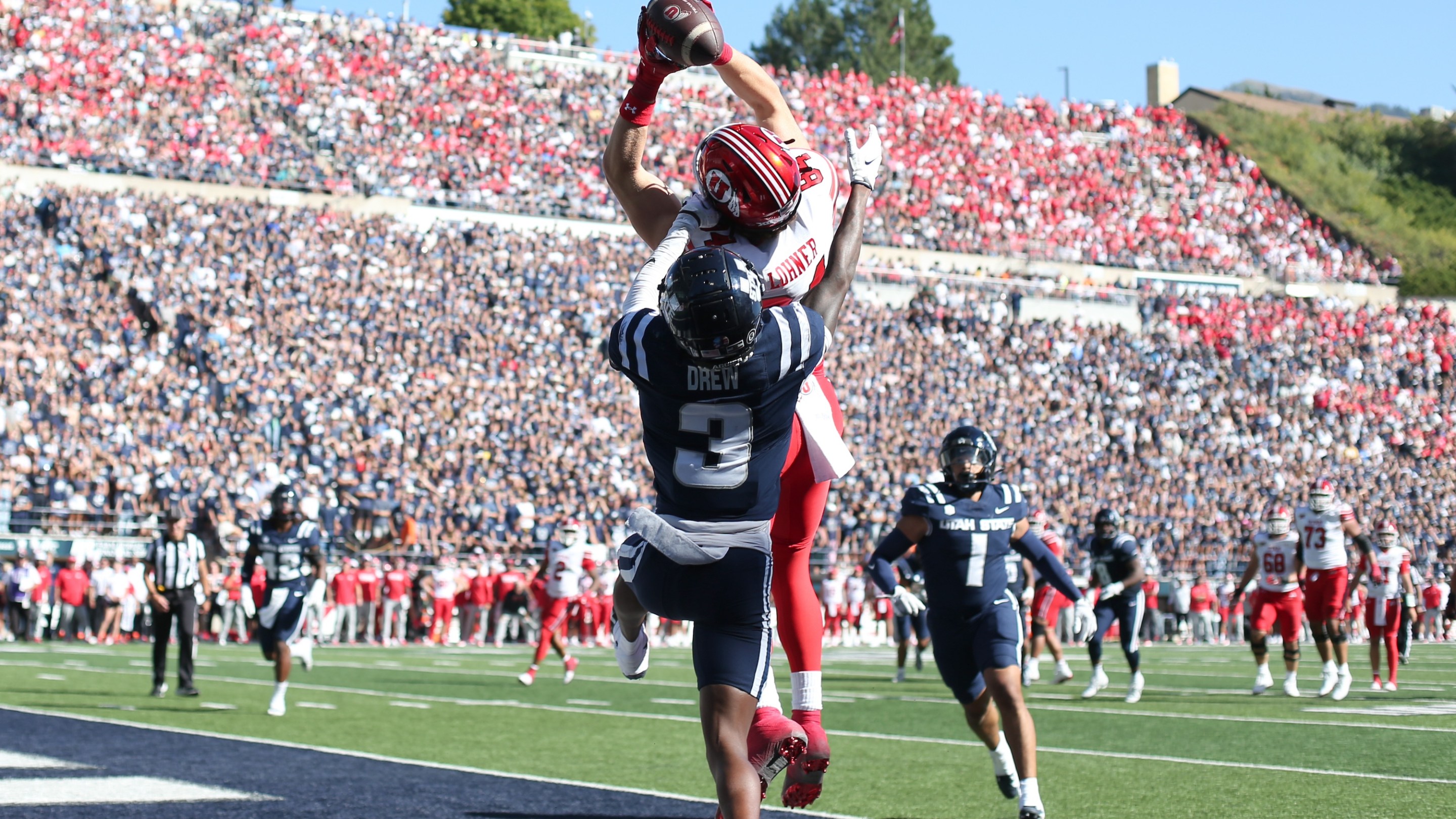 LOGAN, UT - SEPTEMBER 14: Caleb Lohner #84 of the Utah Utes catches a touchdown pass over JD Drew #3 of the Utah State Aggies during the first half of their game at Maverik Stadium on September 14, 2024 in Logan, Utah.(Photo by Chris Gardner/Getty Images)