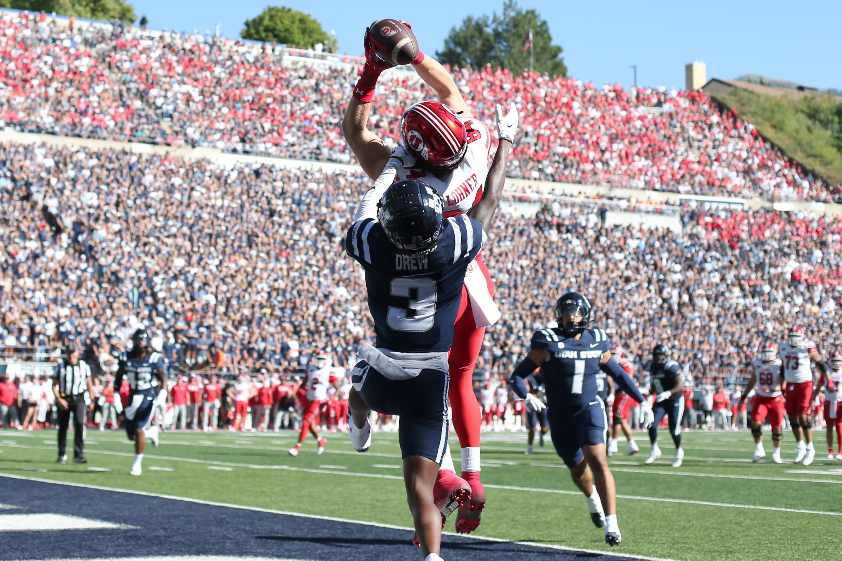 LOGAN, UT - SEPTEMBER 14: Caleb Lohner #84 of the Utah Utes catches a touchdown pass over JD Drew #3 of the Utah State Aggies during the first half of their game at Maverik Stadium on September 14, 2024 in Logan, Utah.(Photo by Chris Gardner/Getty Images)