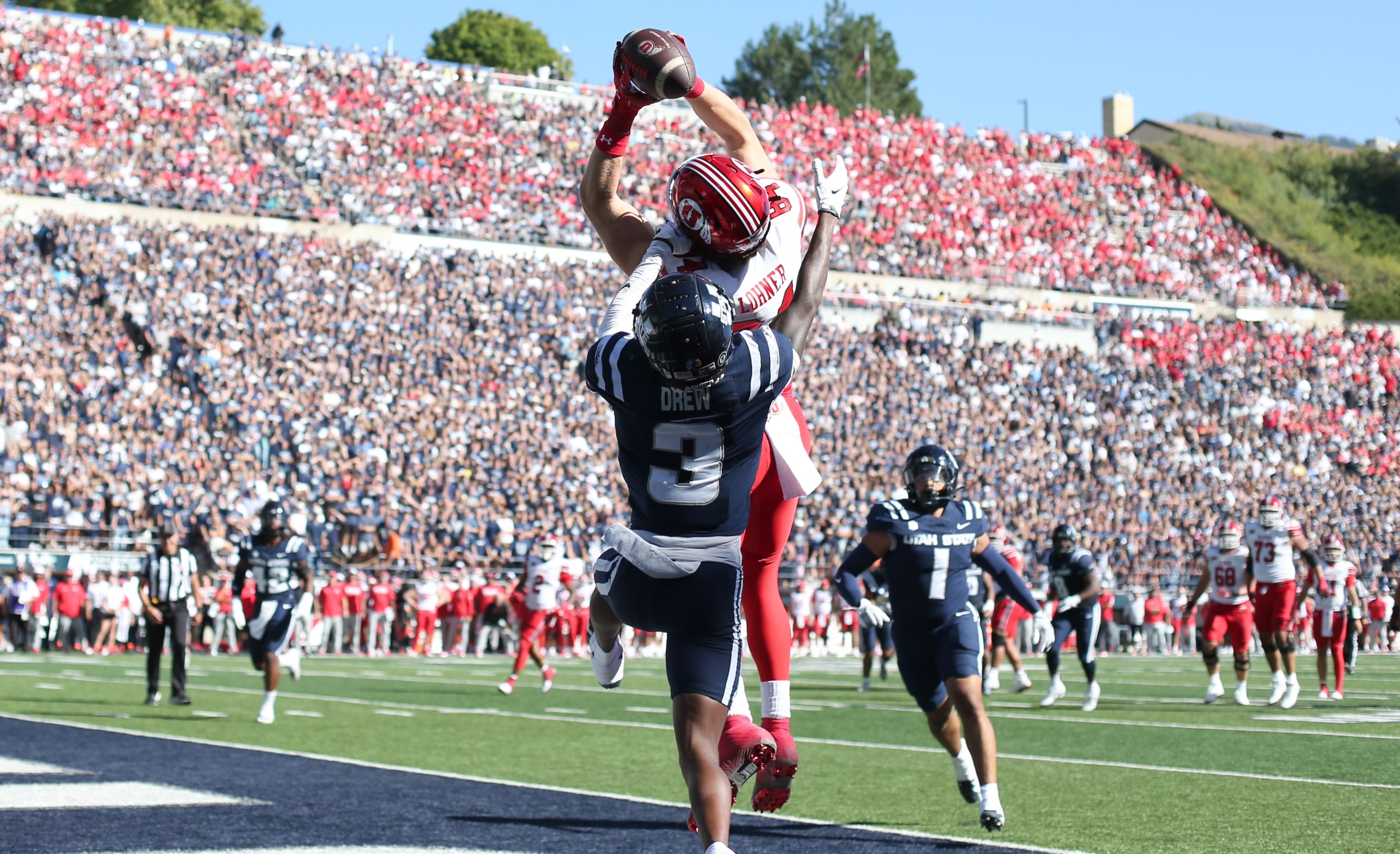 LOGAN, UT - SEPTEMBER 14: Caleb Lohner #84 of the Utah Utes catches a touchdown pass over JD Drew #3 of the Utah State Aggies during the first half of their game at Maverik Stadium on September 14, 2024 in Logan, Utah.(Photo by Chris Gardner/Getty Images)