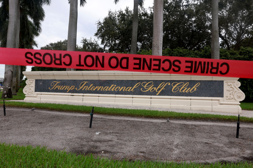 Red crime scene tape marking off an area outside the Trump International Golf Club sign in West Palm Beach, Florida, as law enforcement investigate an apparent assassination attempt on Donald Trump.