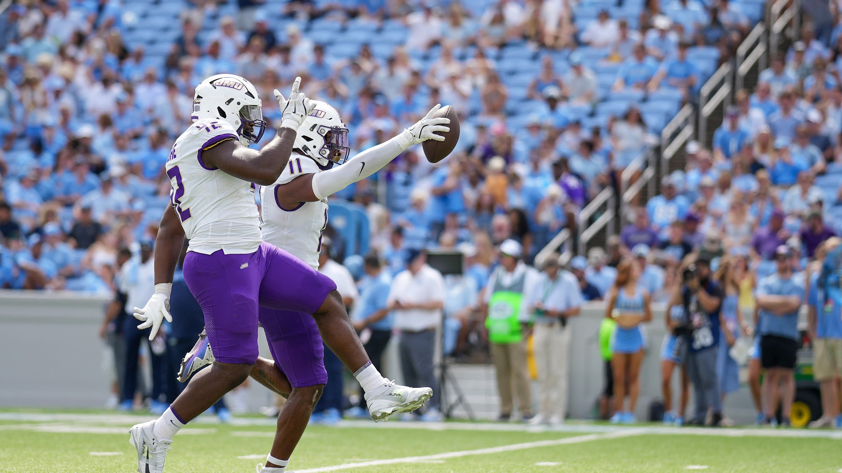 Darold DeNgohe and Khairi Manns of the James Madison Dukes react after recovering a turnover against the North Carolina Tar Heels during the first half of the game on September 21, 2024 in Chapel Hill, North Carolina. James Madison would win 70-50.