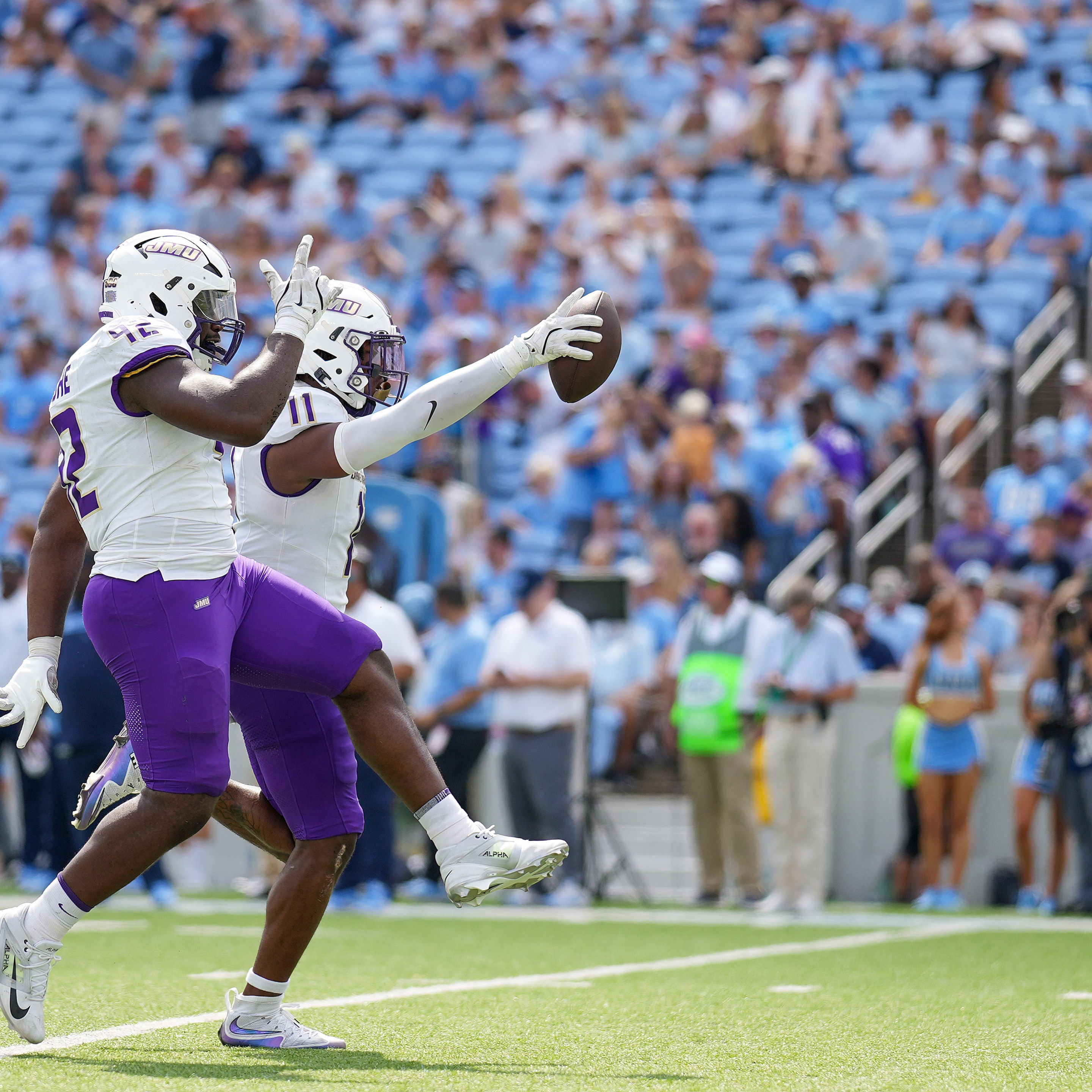 Darold DeNgohe and Khairi Manns of the James Madison Dukes react after recovering a turnover against the North Carolina Tar Heels during the first half of the game on September 21, 2024 in Chapel Hill, North Carolina. James Madison would win 70-50.
