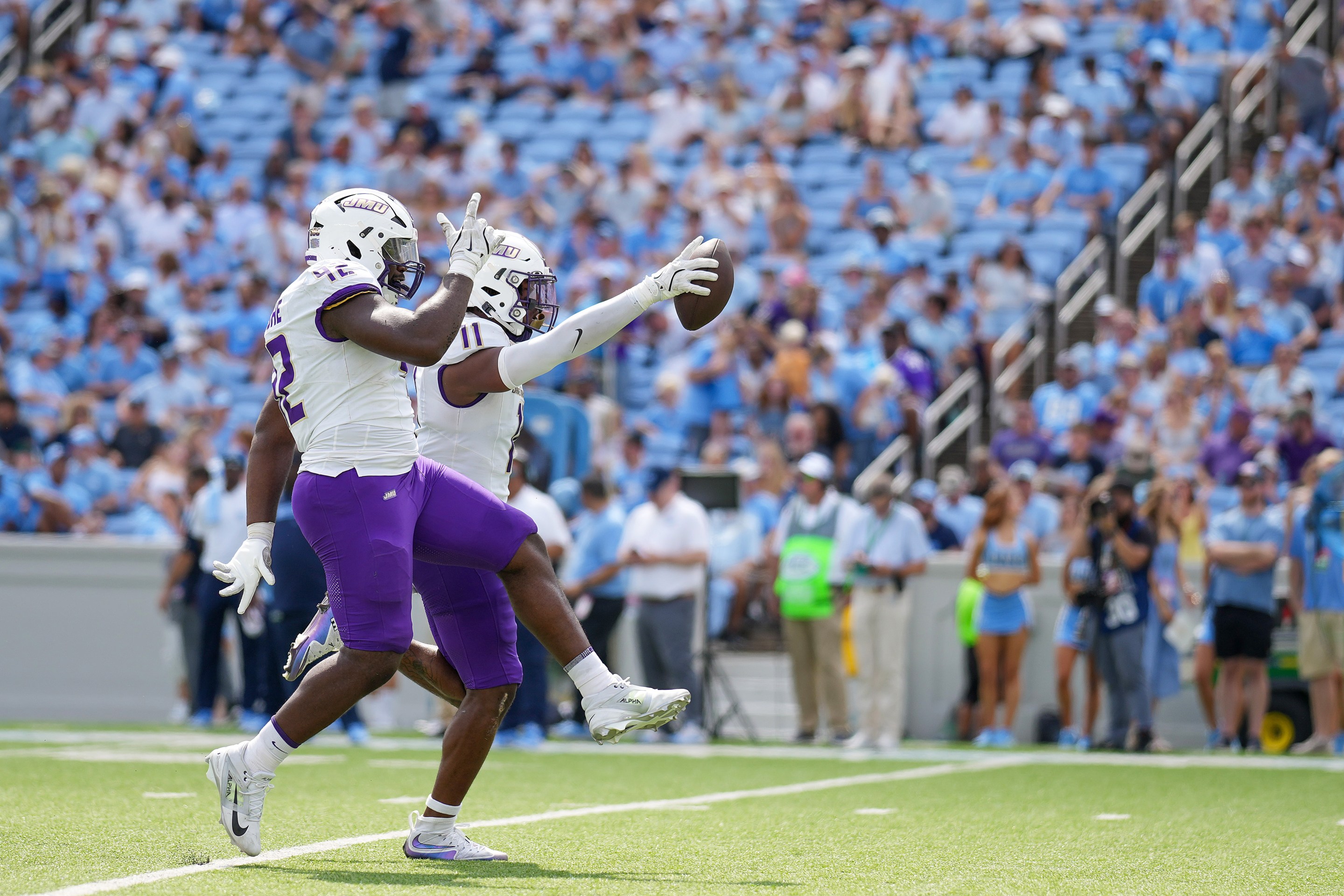 Darold DeNgohe and Khairi Manns of the James Madison Dukes react after recovering a turnover against the North Carolina Tar Heels during the first half of the game on September 21, 2024 in Chapel Hill, North Carolina. James Madison would win 70-50.