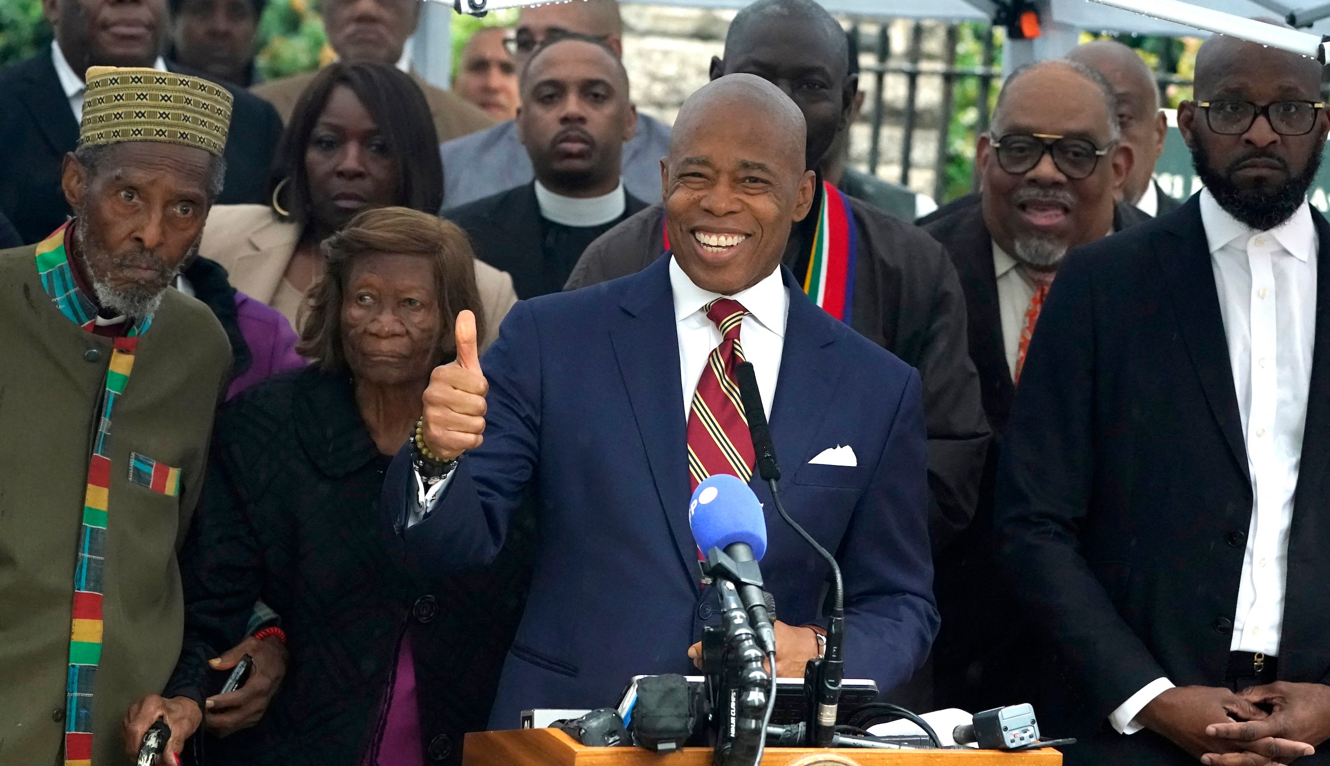 New York City Mayor Eric Adams talks to the press outside Gracie Mansion, the official residence of the mayor of New York City, on September 26, 2024, after he was indicted on federal criminal charges. US federal agents raided the official residence of Mayor Adams early September 26 ahead of the expected announcement of criminal charges against the former city cop once touted as a rising Democratic Party star. The search at the residence known as Gracie Mansion began before dawn, and is the latest shock twist in a graft investigation against the Adams administration. (Photo by TIMOTHY A. CLARY / POOL / AFP)