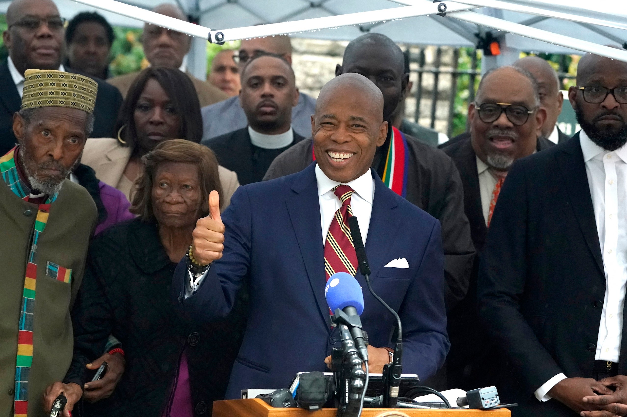 New York City Mayor Eric Adams talks to the press outside Gracie Mansion, the official residence of the mayor of New York City, on September 26, 2024, after he was indicted on federal criminal charges. US federal agents raided the official residence of Mayor Adams early September 26 ahead of the expected announcement of criminal charges against the former city cop once touted as a rising Democratic Party star. The search at the residence known as Gracie Mansion began before dawn, and is the latest shock twist in a graft investigation against the Adams administration. (Photo by TIMOTHY A. CLARY / POOL / AFP)