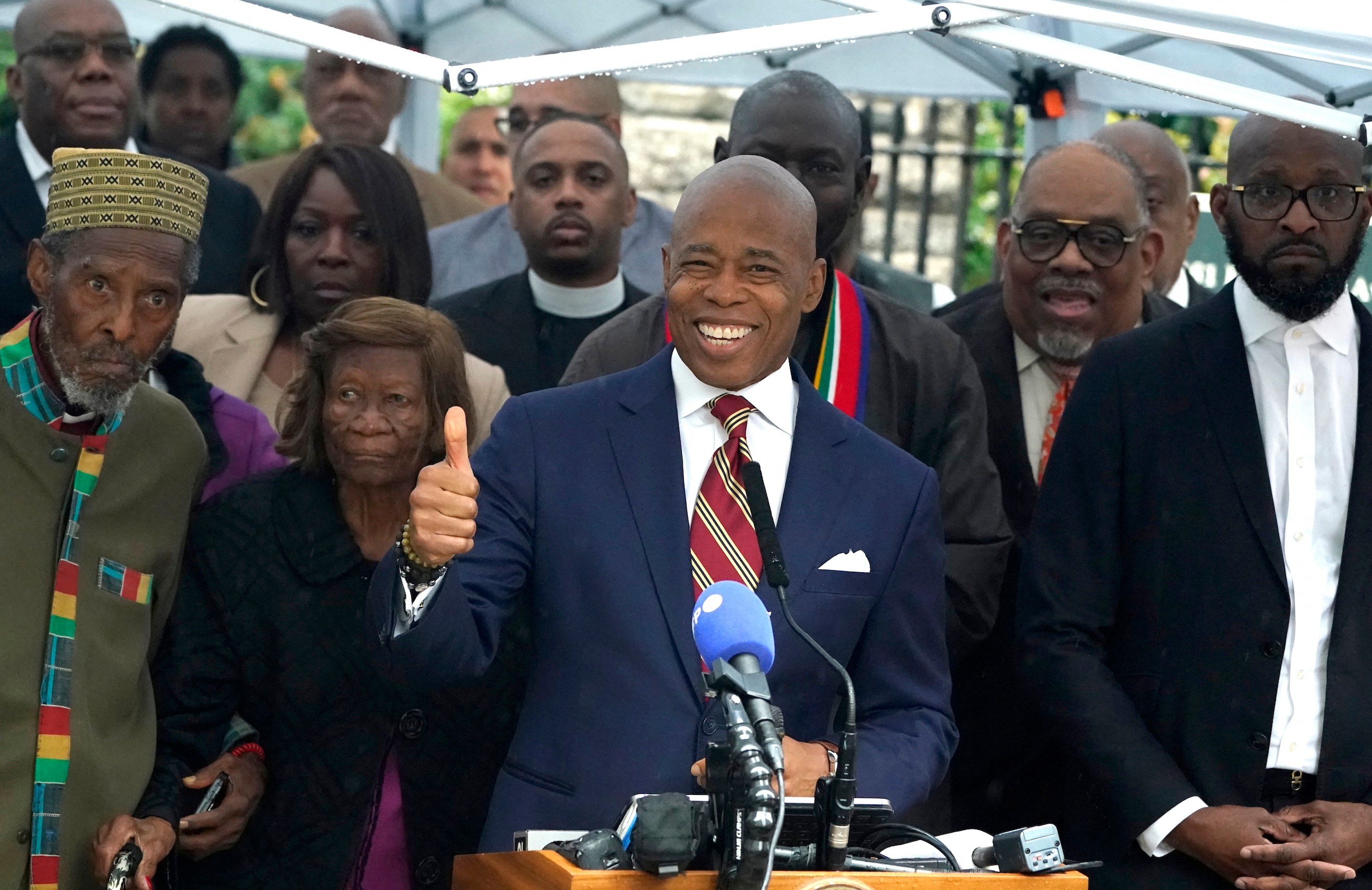 New York City Mayor Eric Adams talks to the press outside Gracie Mansion, the official residence of the mayor of New York City, on September 26, 2024, after he was indicted on federal criminal charges. US federal agents raided the official residence of Mayor Adams early September 26 ahead of the expected announcement of criminal charges against the former city cop once touted as a rising Democratic Party star. The search at the residence known as Gracie Mansion began before dawn, and is the latest shock twist in a graft investigation against the Adams administration. (Photo by TIMOTHY A. CLARY / POOL / AFP)