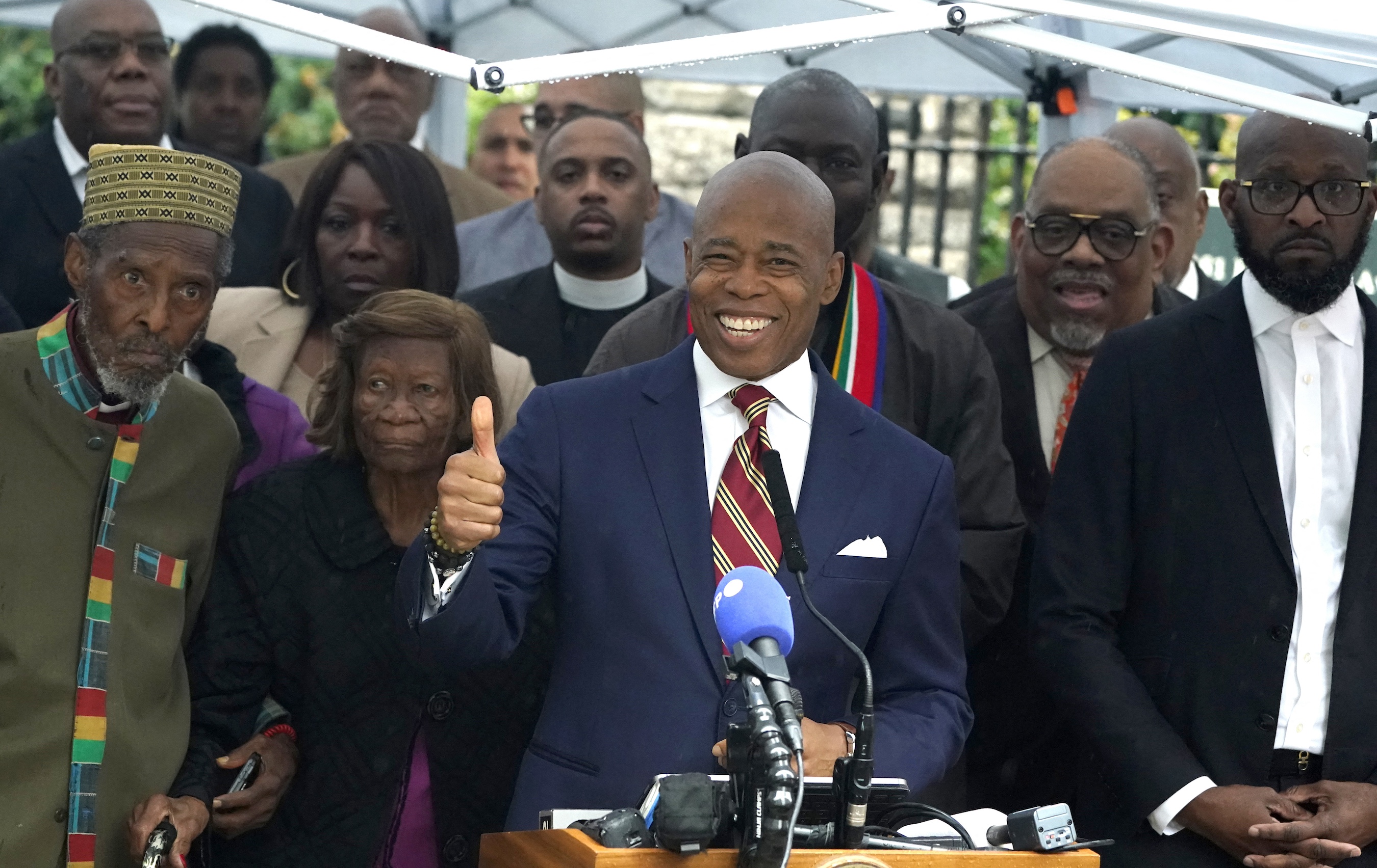 New York City Mayor Eric Adams talks to the press outside Gracie Mansion, the official residence of the mayor of New York City, on September 26, 2024, after he was indicted on federal criminal charges. US federal agents raided the official residence of Mayor Adams early September 26 ahead of the expected announcement of criminal charges against the former city cop once touted as a rising Democratic Party star. The search at the residence known as Gracie Mansion began before dawn, and is the latest shock twist in a graft investigation against the Adams administration. (Photo by TIMOTHY A. CLARY / POOL / AFP)