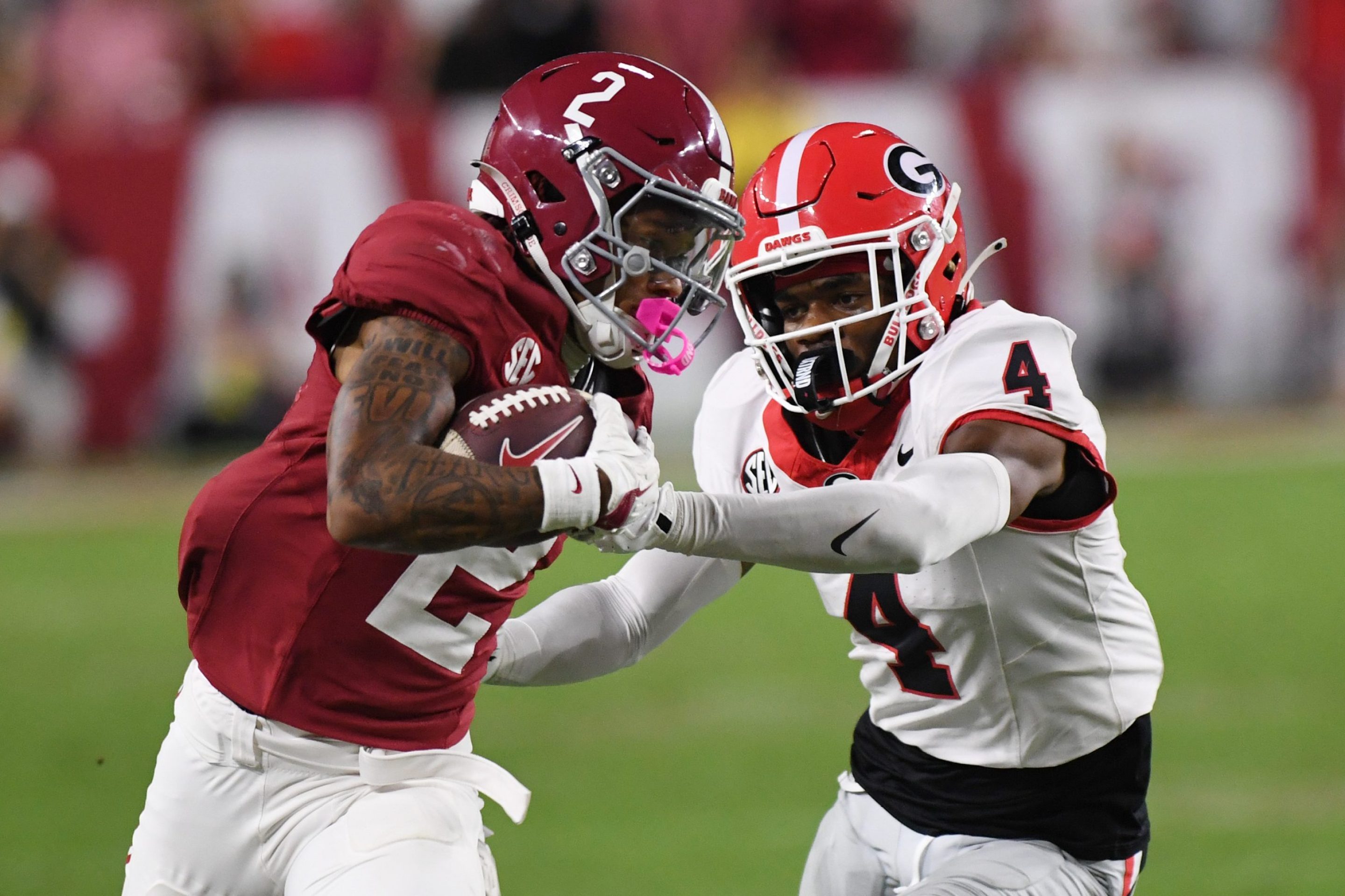 Alabama Crimson Tide wide receiver Ryan Williams (2) rushes the ball as Georgia Bulldogs defensive back KJ Bolden (4) defends during the college football game between the Georgia Bulldogs and the Alabama Crimson Tide on September 28, 2024, at Bryant-Denny Stadium in Tuscaloosa, AL.