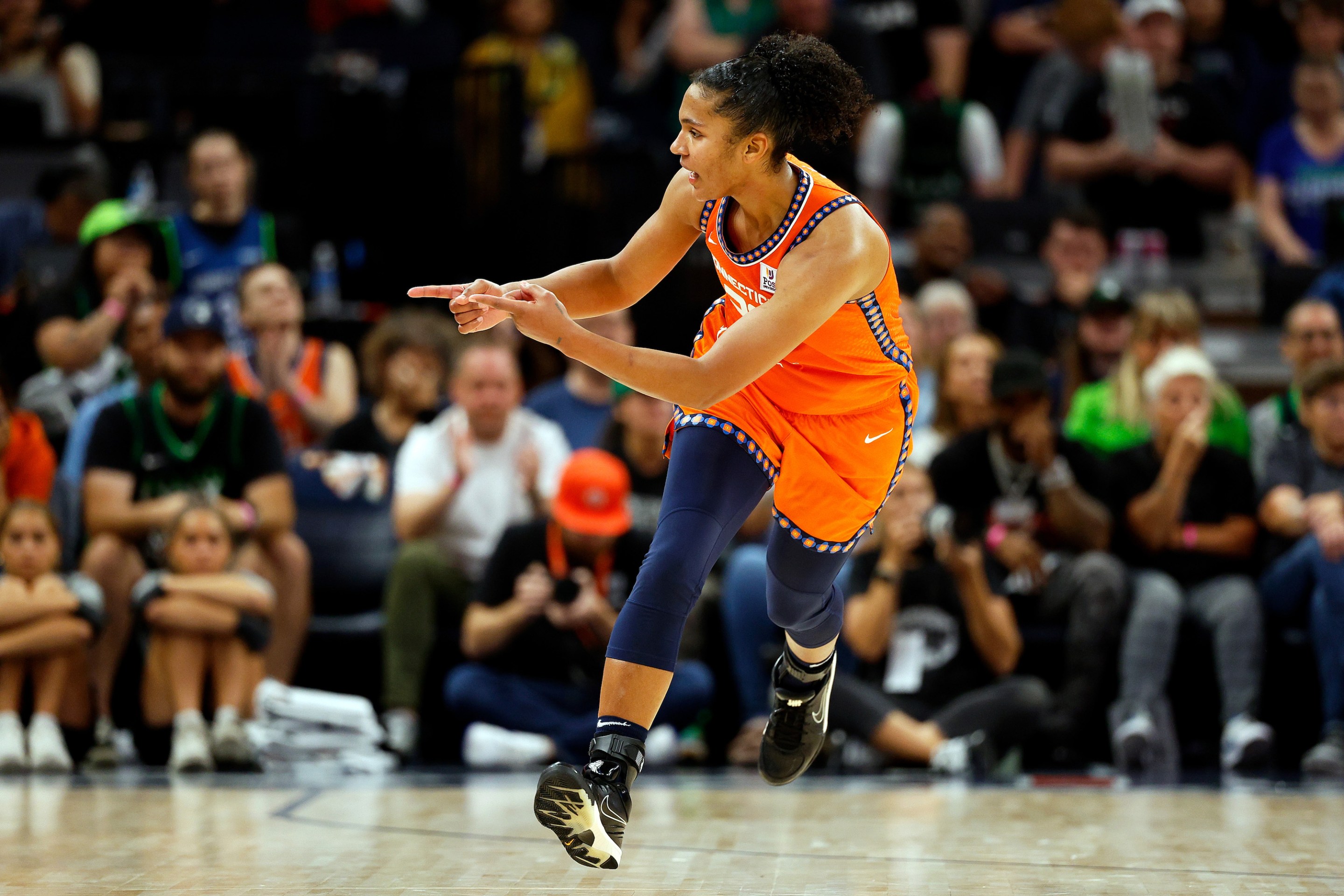 Alyssa Thomas #25 of the Connecticut Sun celebrates her basket against the Minnesota Lynx in the fourth quarter of Game One of the Semi-Finals during the WNBA Playoffs at Target Center on September 29, 2024 in Minneapolis, Minnesota. The Sun defeated the Lynx 73-70.