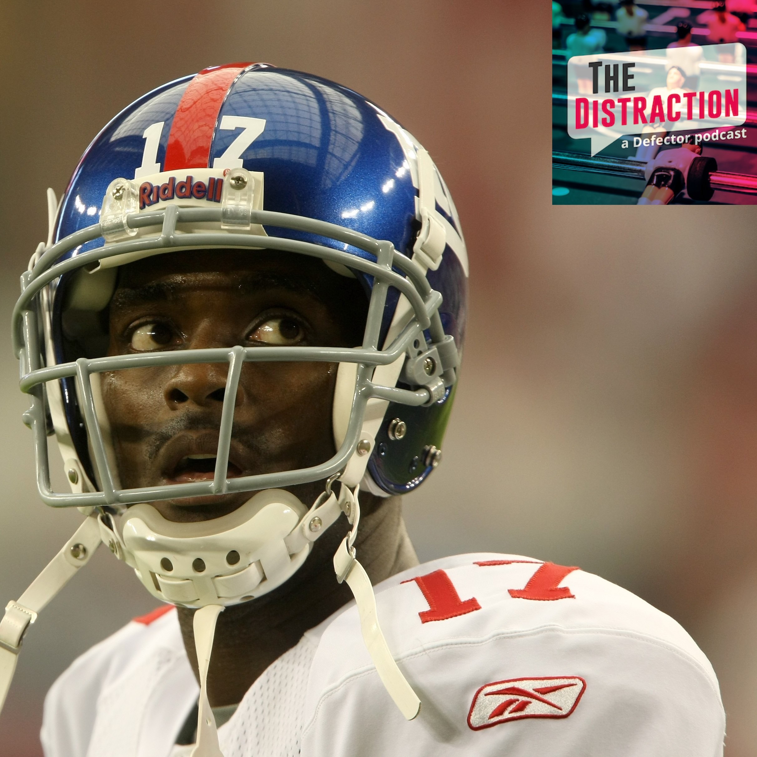 Wide receiver Plaxico Burress #17 of the New York Giants warms up for the game with the Arizona Cardinals on November 23, 2008. It looks like he's looking at the Distraction logo at upper right of the frame.